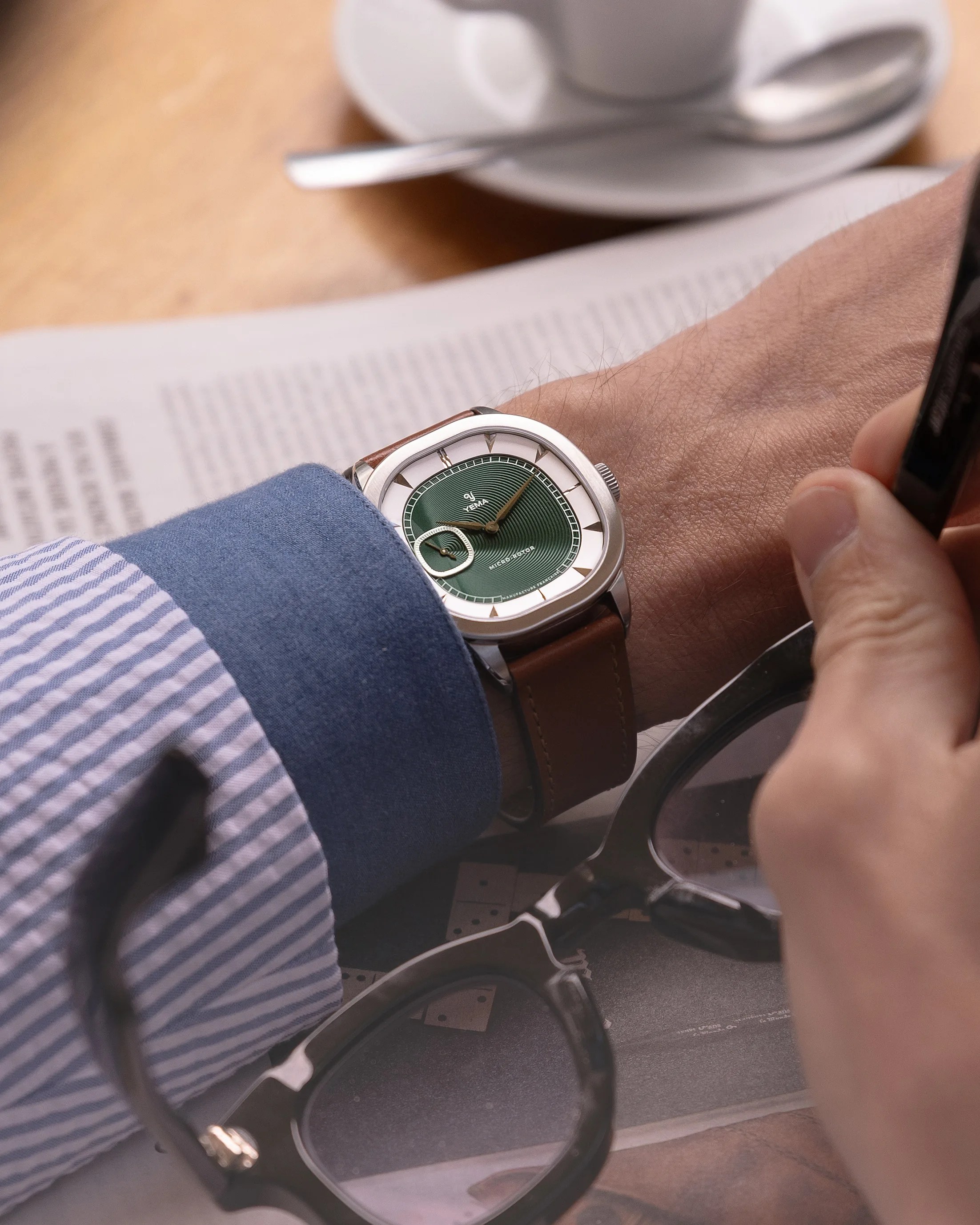 a green dial Yema dress watch on a man's wrist