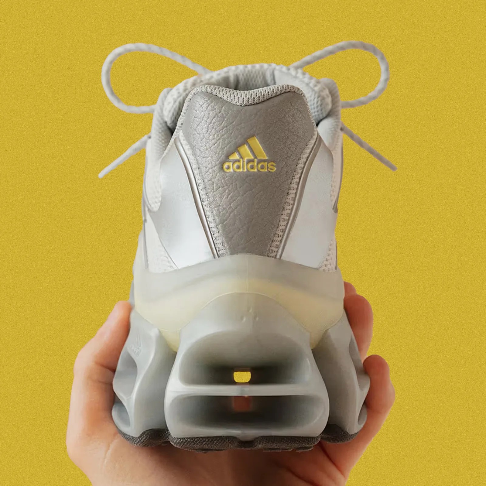The hell of the Adidas Megarise AG shown in full against a speckled yellow background.