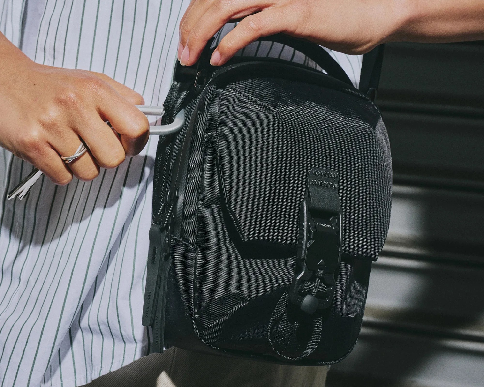 Aer Street Sling EDC Crossbody Pack on hip with carabiner attached