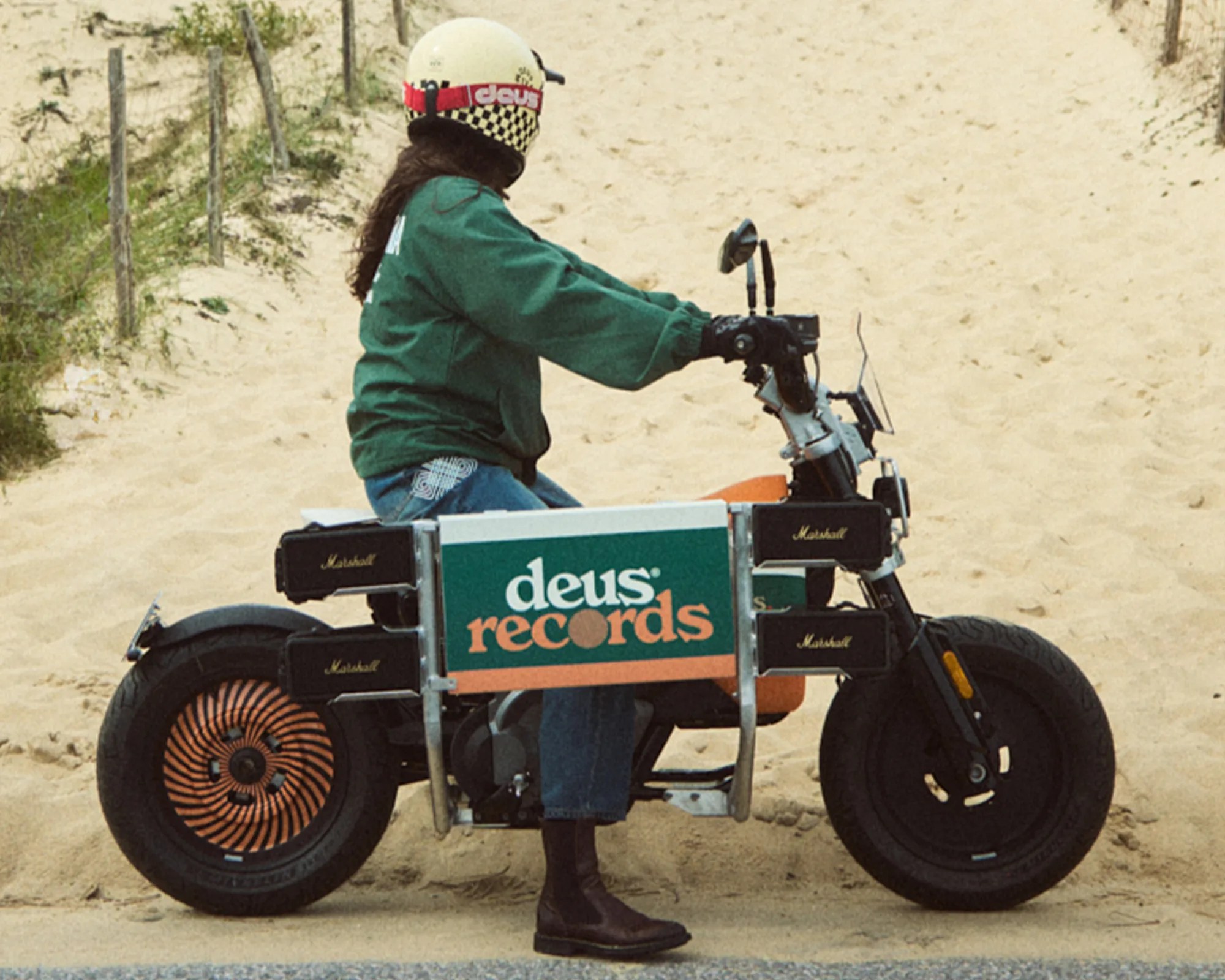 BMW x Deus Ex Machina DE 02 Electric Motorcycle on beach sand