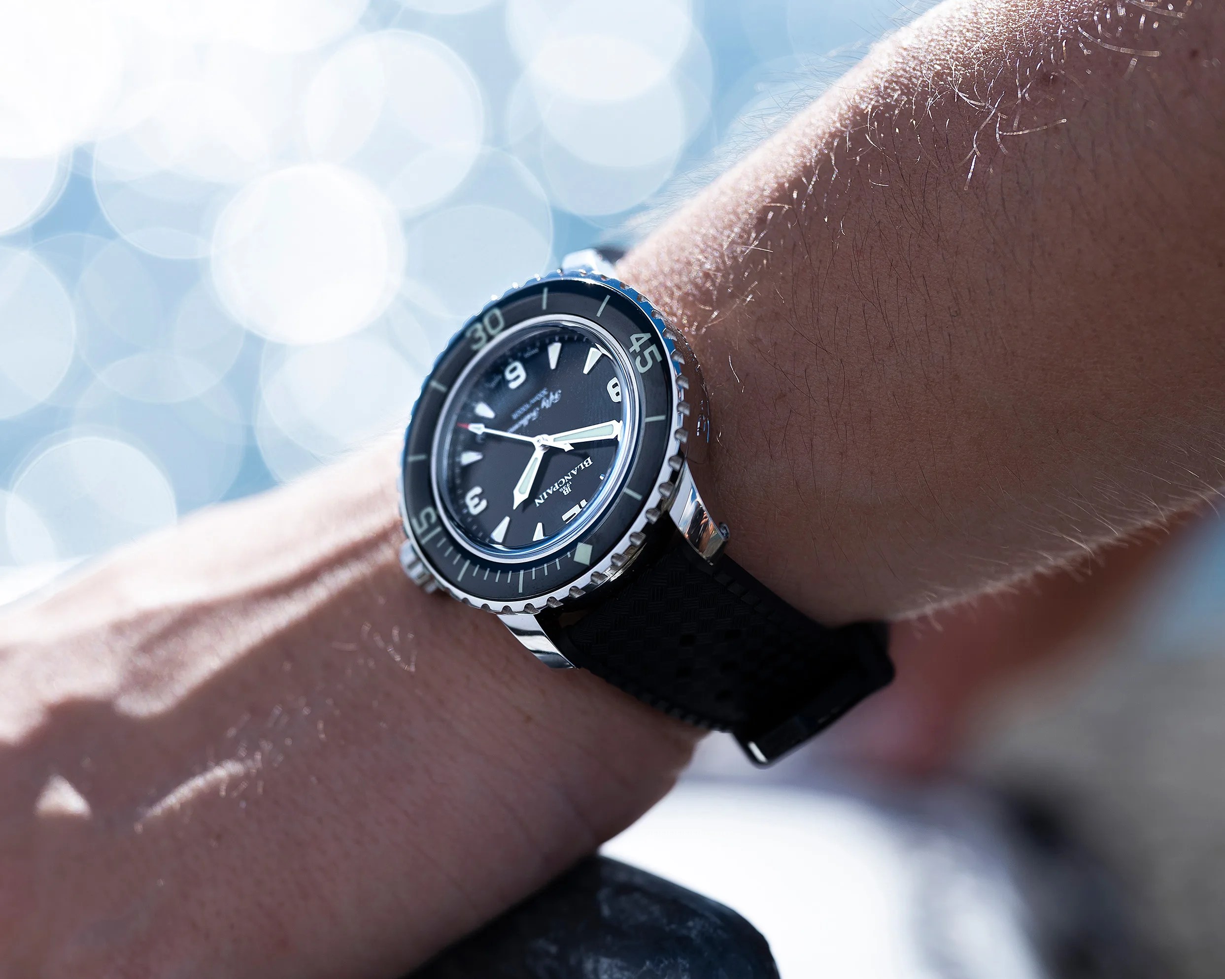 a black Blancpain dive watch on a man's wrist