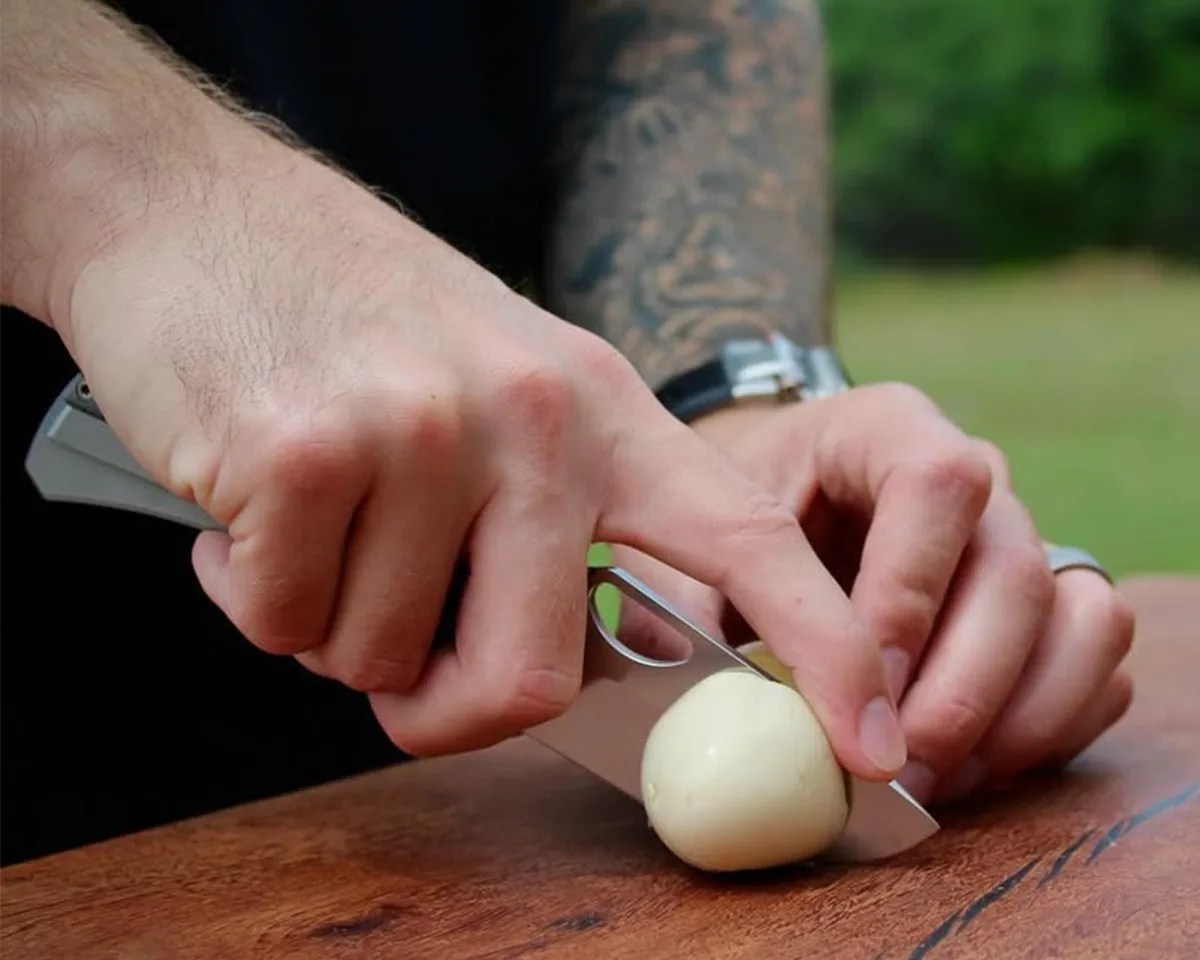 Deadman Design Co Elixir EDC Knife cutting a pickled egg