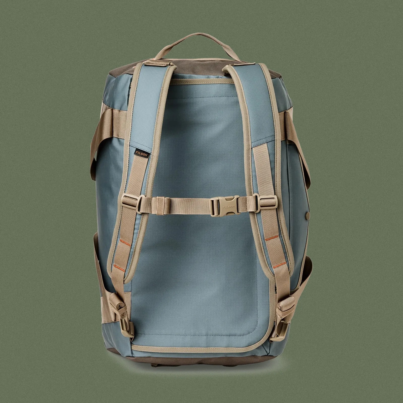 Filson Scout All-Weather 50L Duffle Bag shown in backpack mode against a dark green background