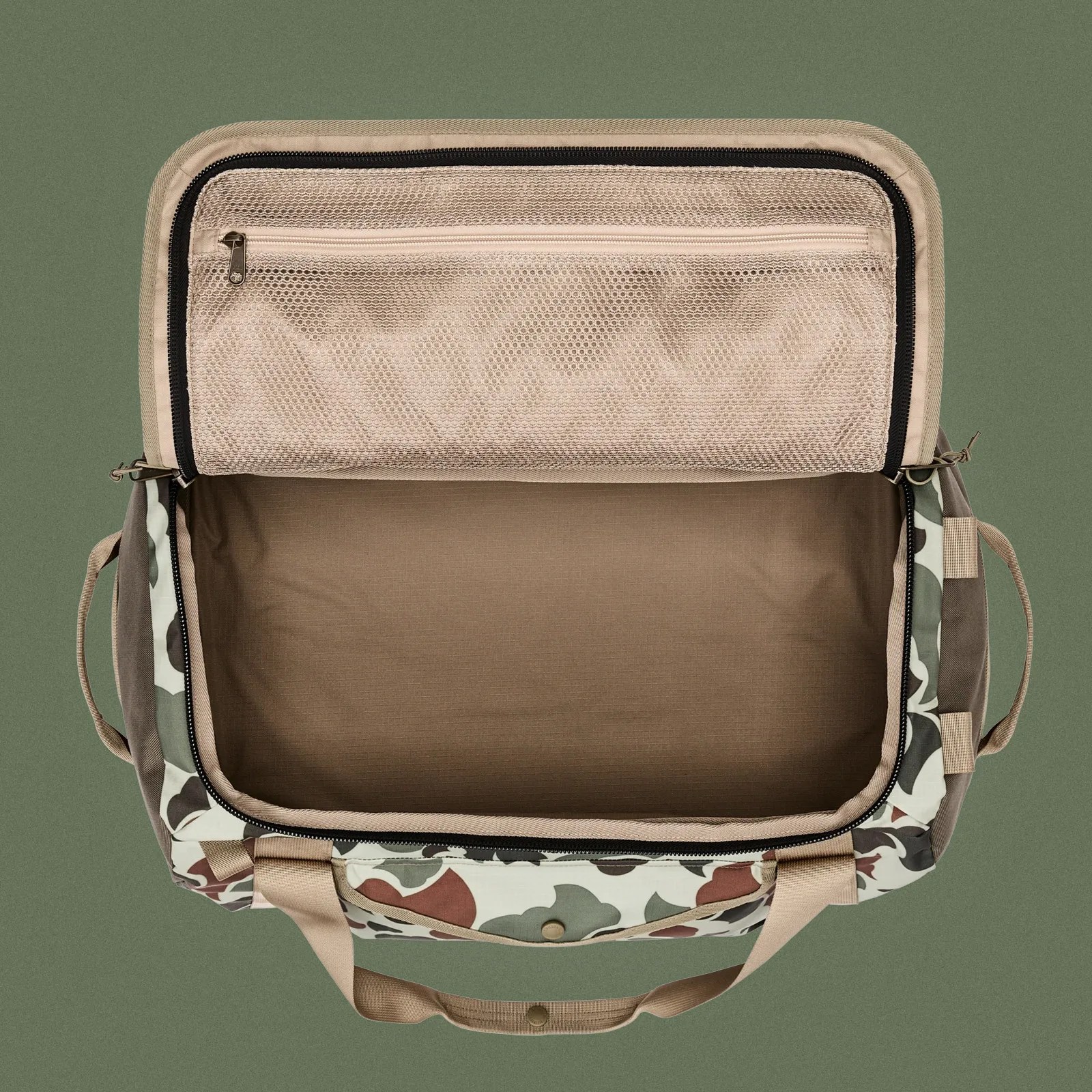 The Filson Scout All-Weather 50L Duffle shown unzipped and open from above against a dark green background