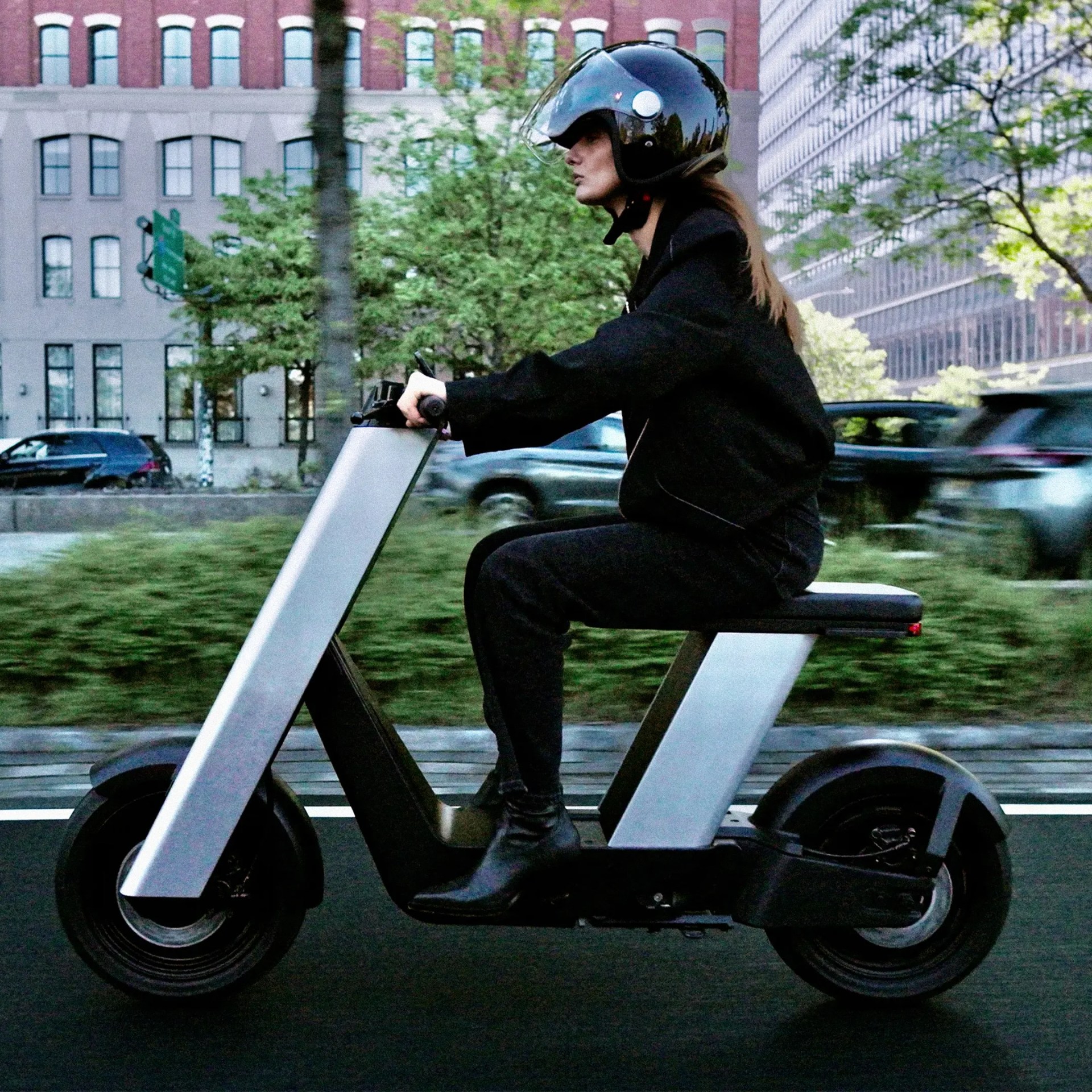 Person riding Infinite Machine Olto eBike through the city