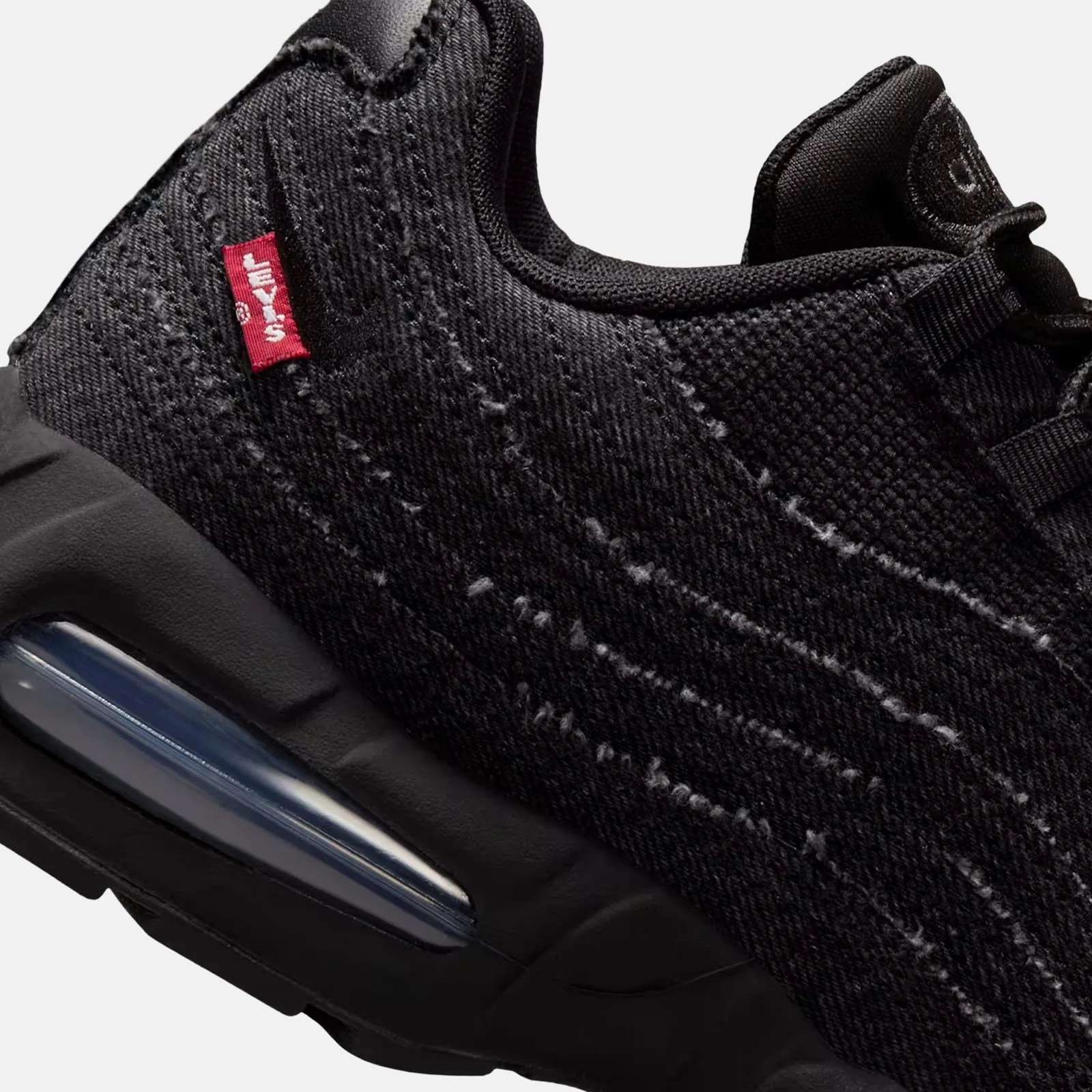 A close-up of the heel of the Levi's x Nike Air Max 95 in black showing the Levi's red tag