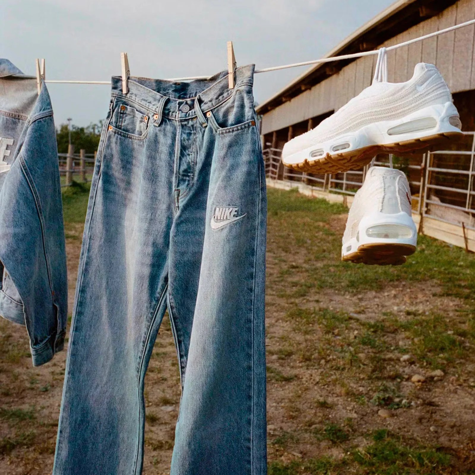A pair of Nike x Levi's jeans and Nike x Levi's Air Max 95 sneakers in white hanging on a clothes line