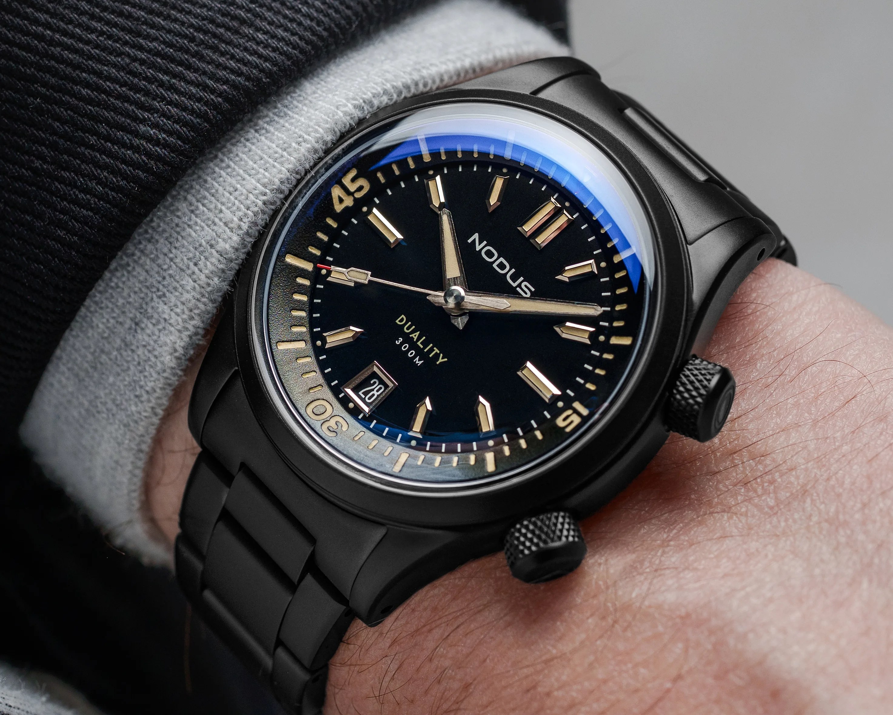 a black Nodus dive watch on a man's wrist