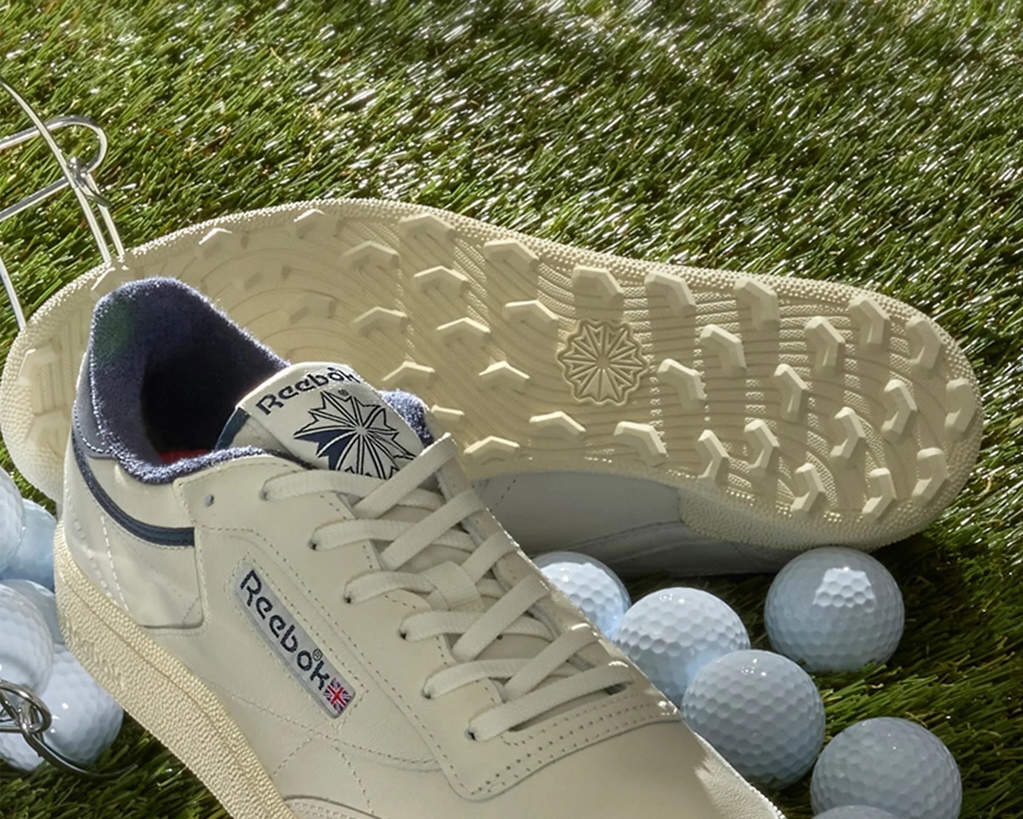 Reebok Club C Golf Shoes on turf with golf balls, sole closeup