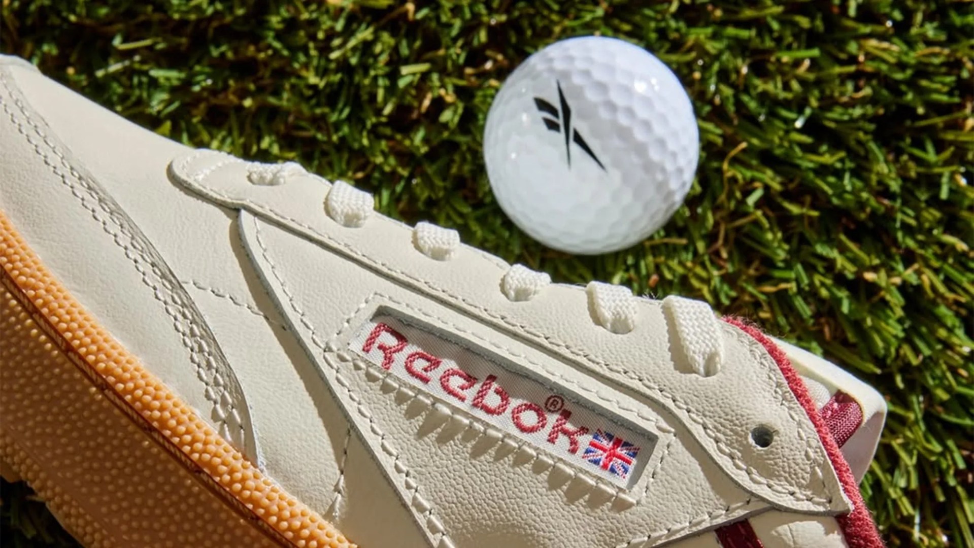 Reebok Club C Golf Shoe closeup with golf ball on grass