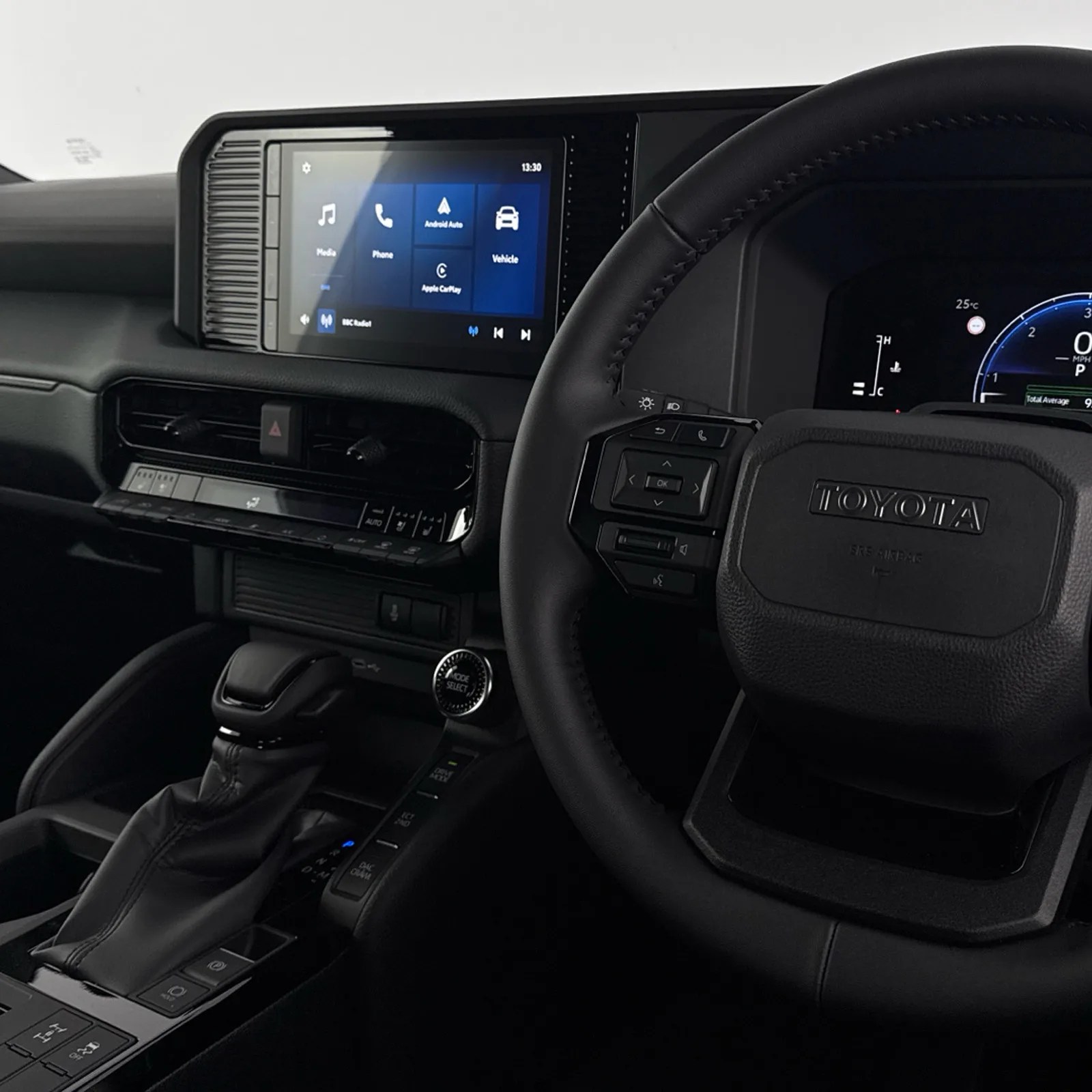 A view of the steering wheel and infotainment screen of the Toyota Land Cruiser Commercial 