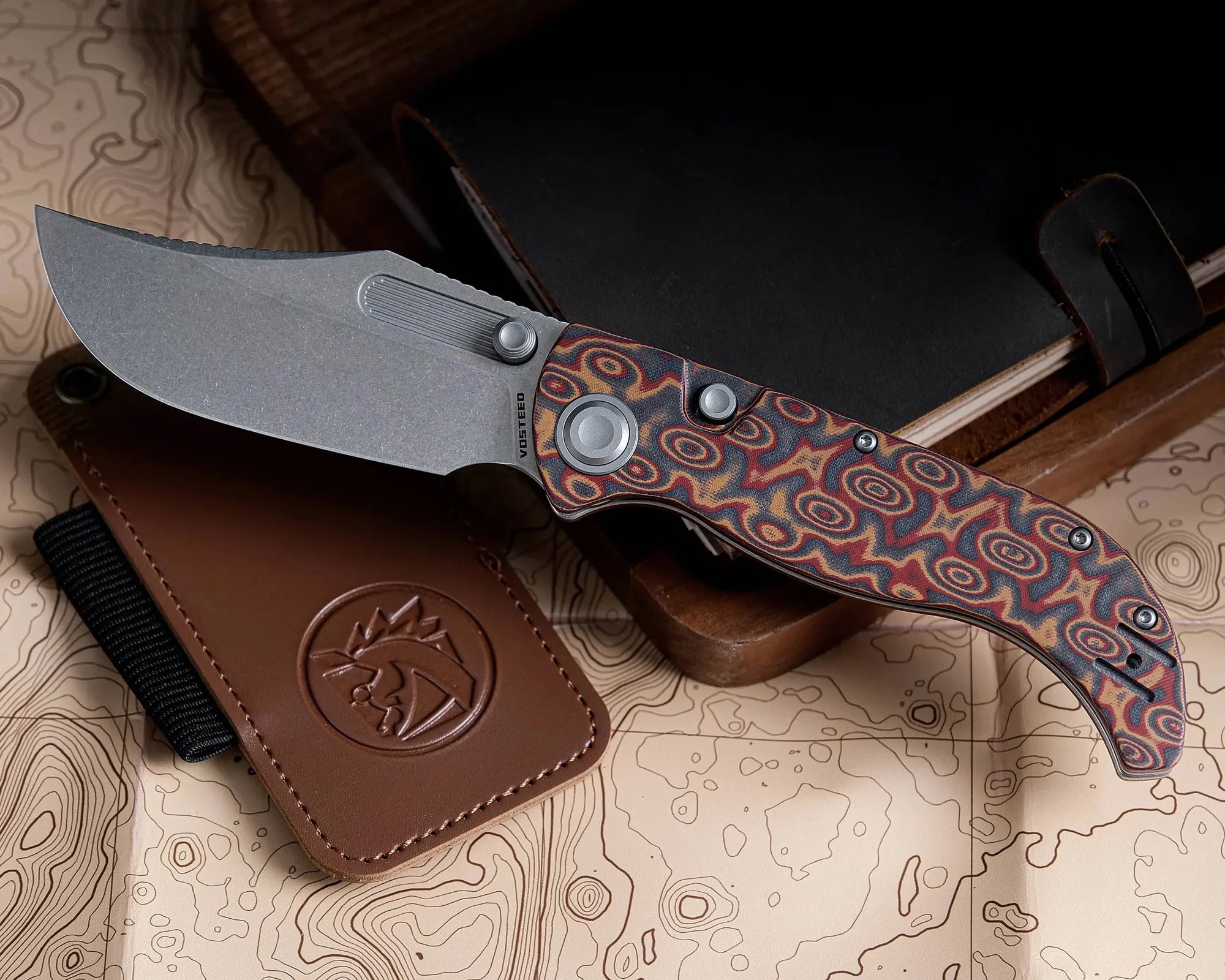 Vosteed Naga EDC Knife in front of topographical map