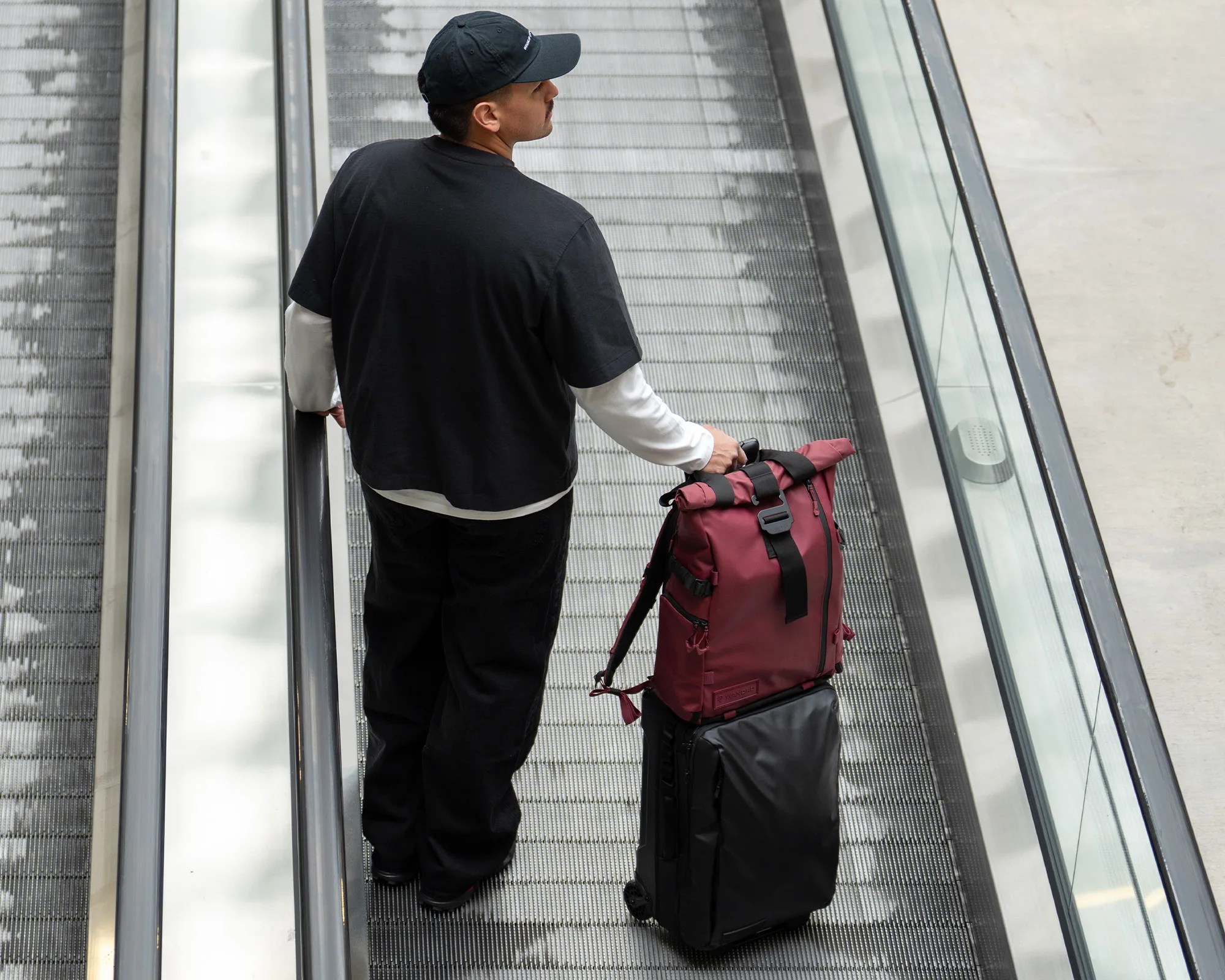 Wandrd Prvke V4 EDC Travel Backpack luggage pass-through on airport moving walkway