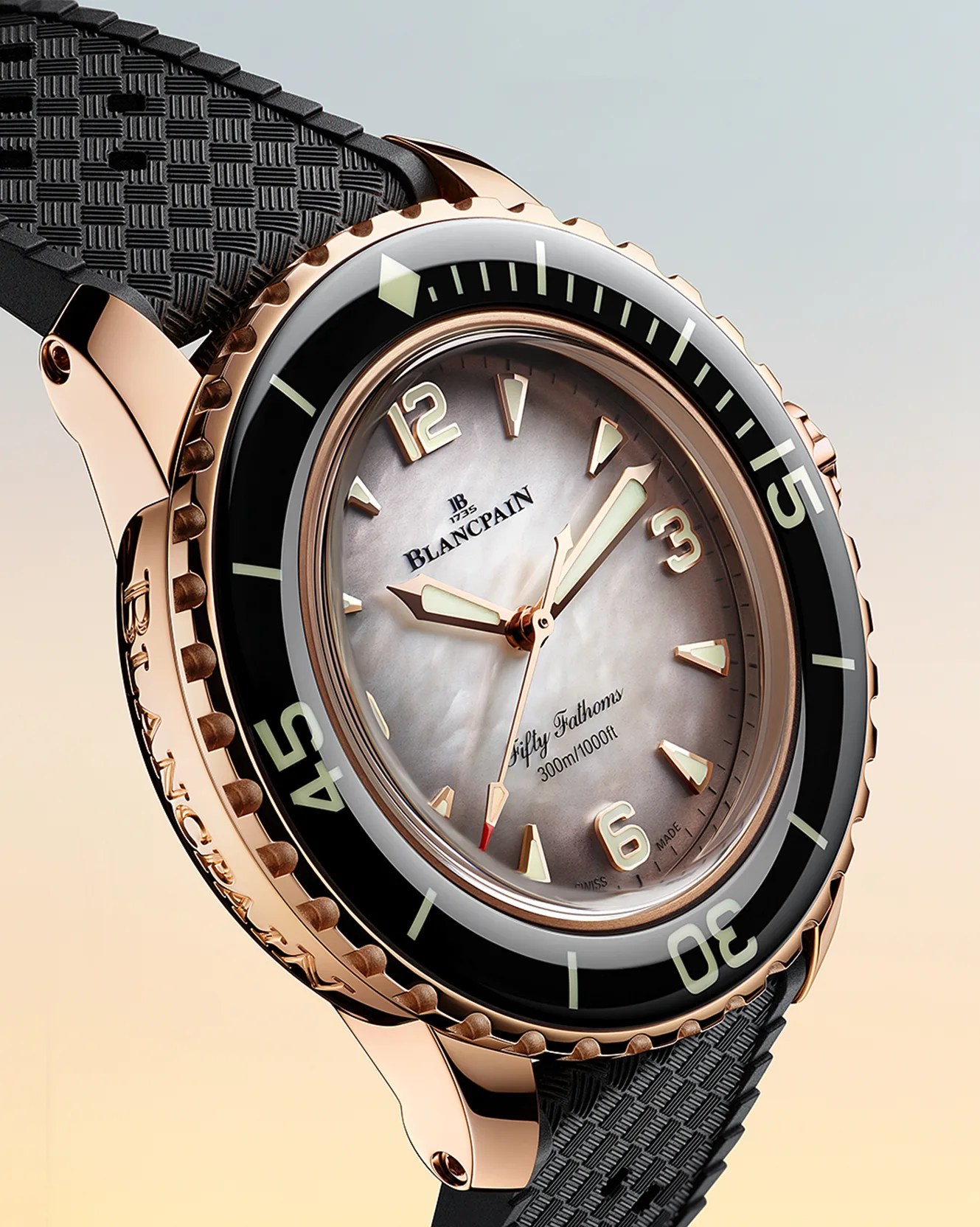 a gold Blancpain dive watch with a pearl dial