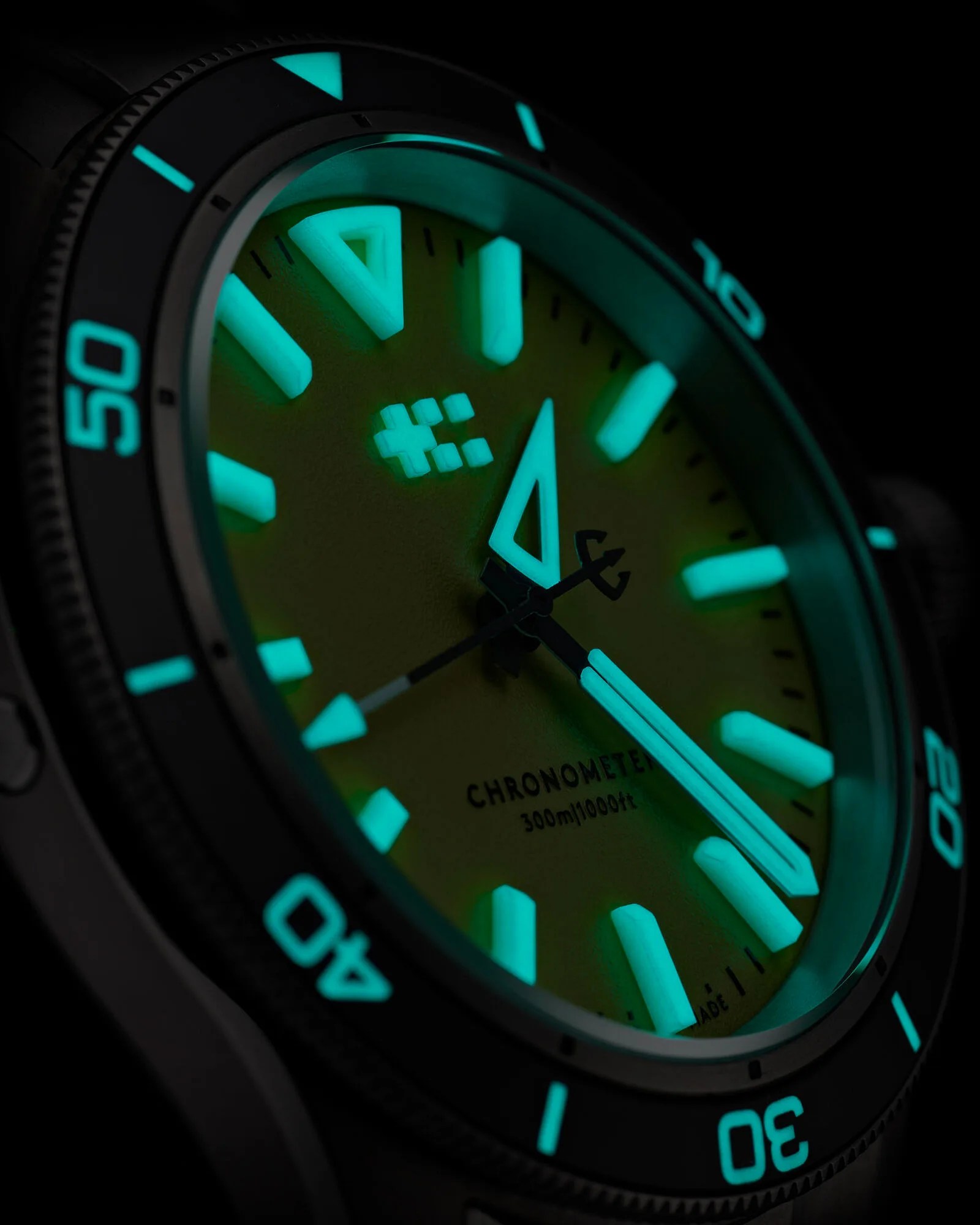 the dial of a Christopher Ward dive watch in the dark