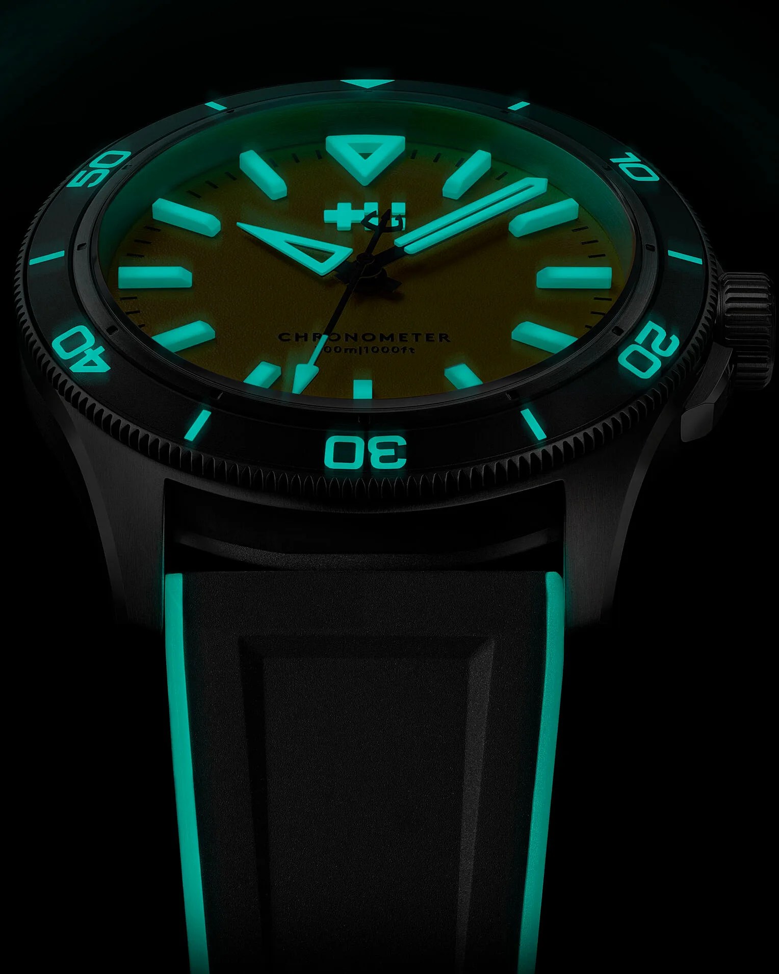 a Christopher Ward dive watch with lume glowing