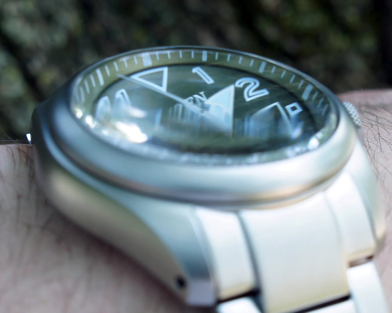 the domed sapphire glass of a Citizen field watch