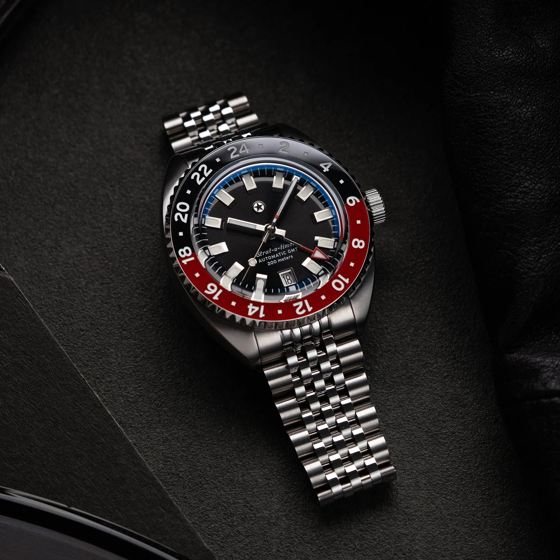 a black and red GMT watch