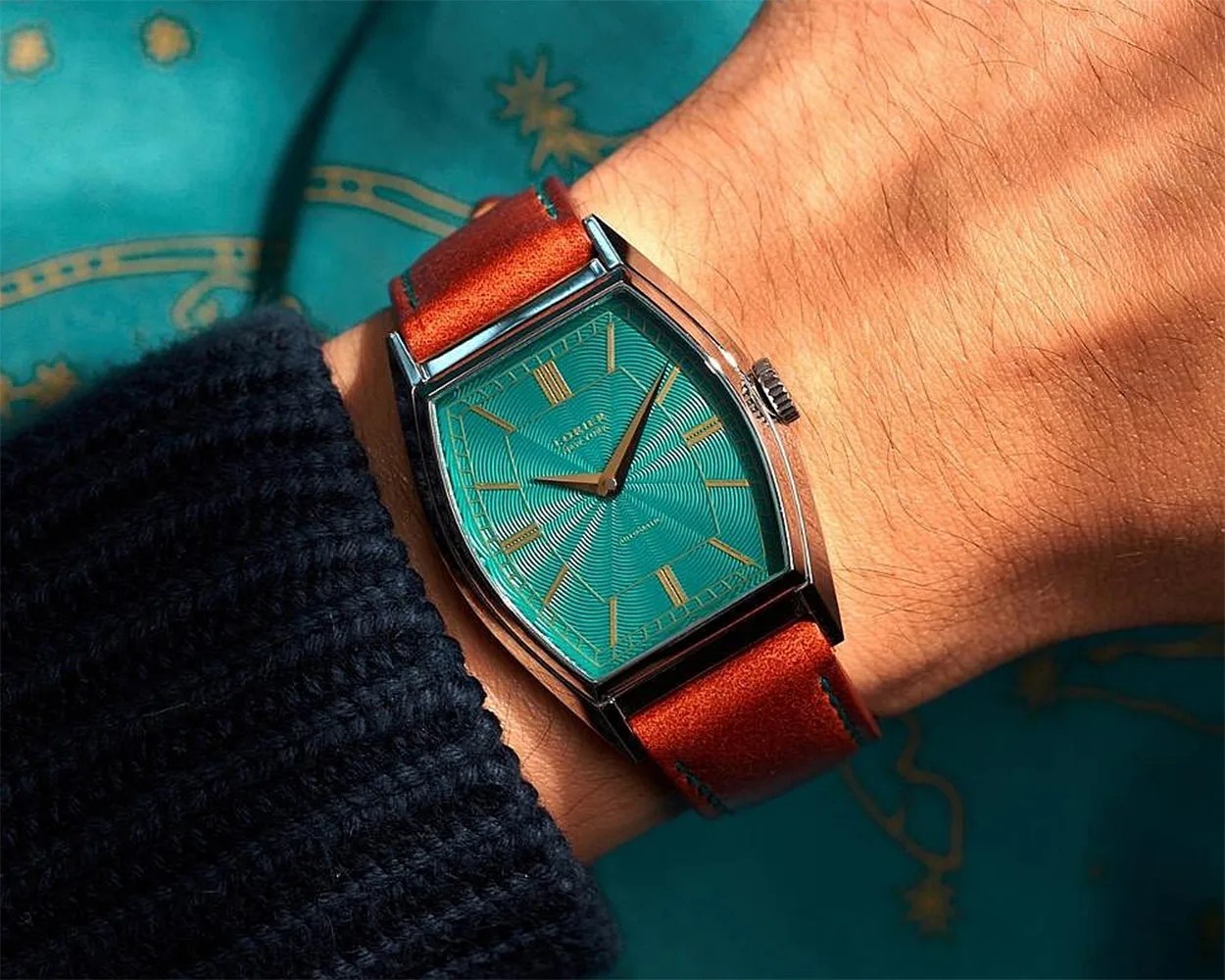 a green Lorier watch on a man's wrist
