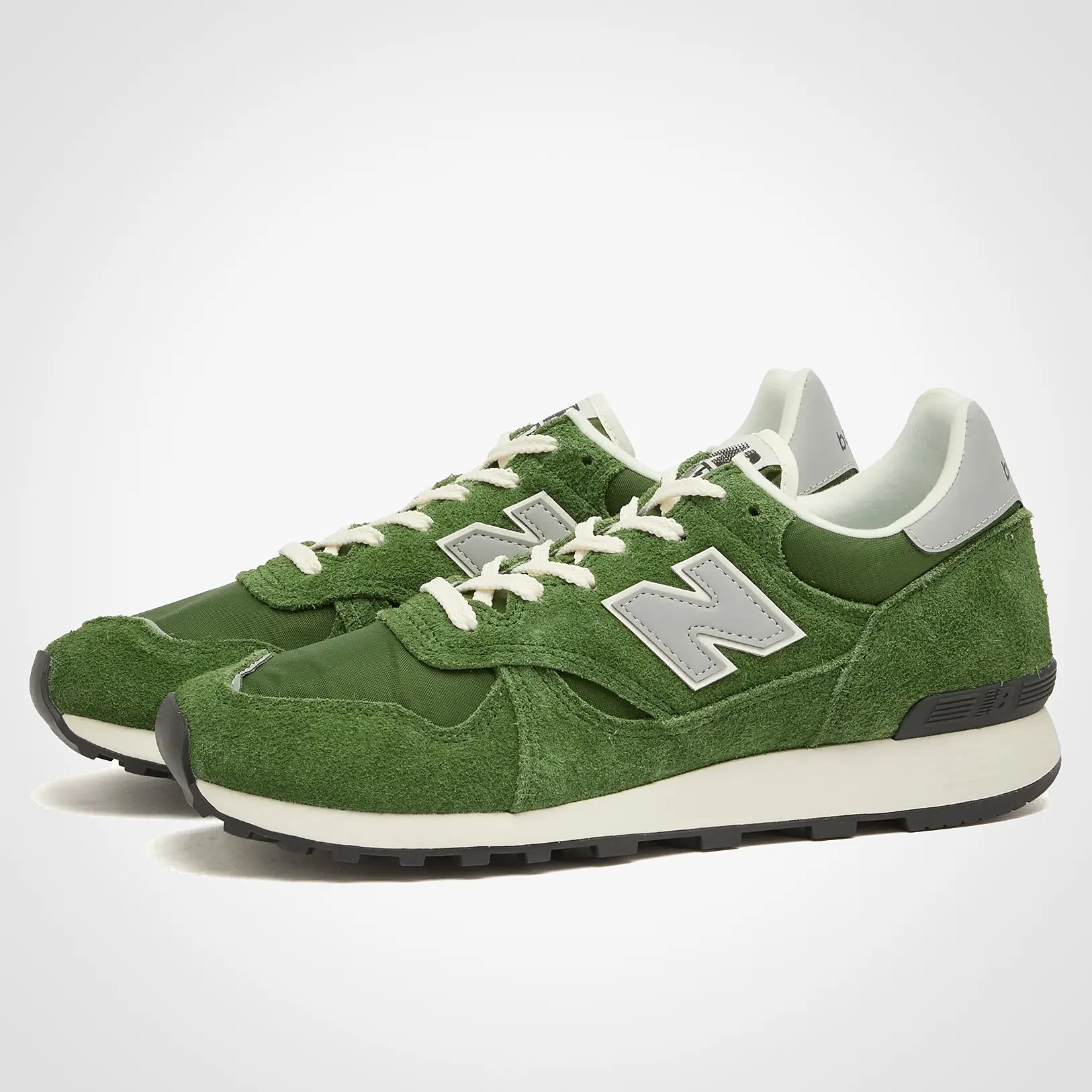 a pair of green new balance sneakers