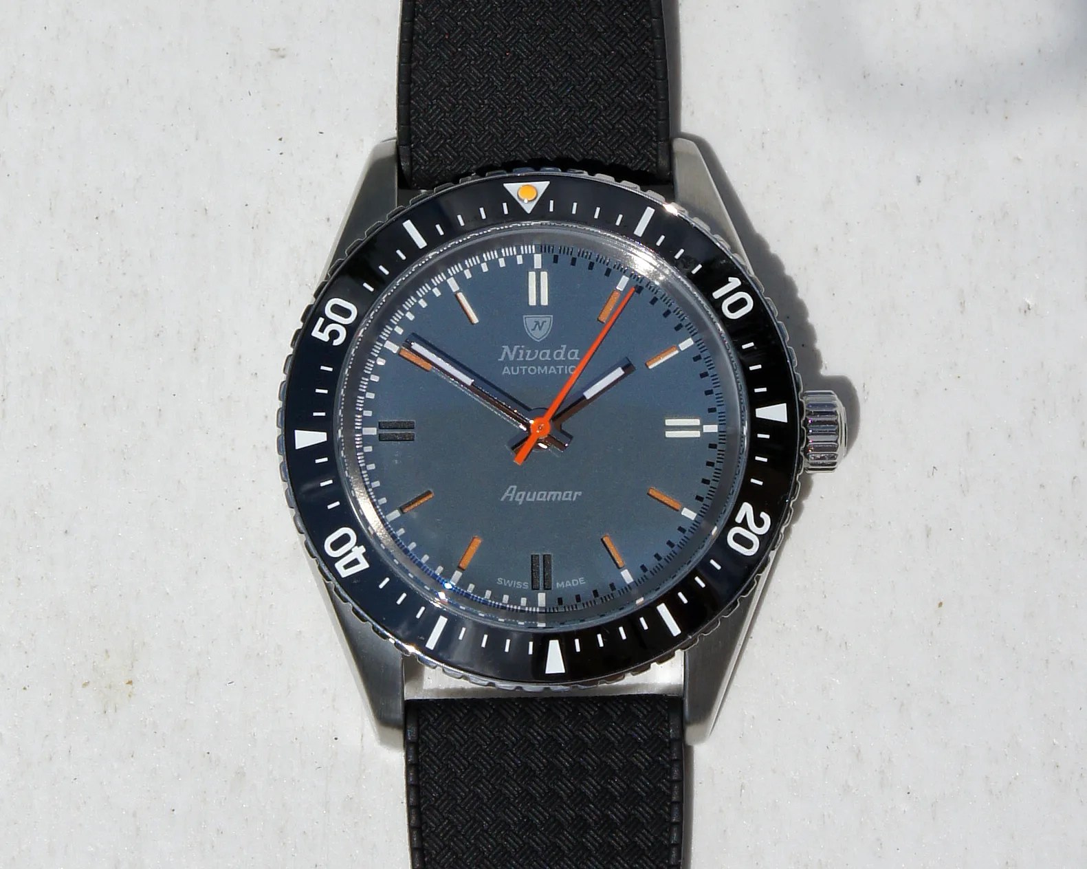 a Nivada dive watch with a blue dial