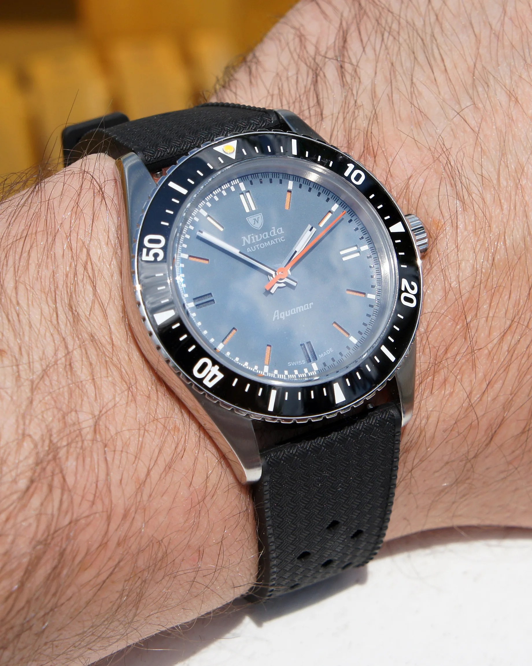 a Nivada dive watch on a man's wrist