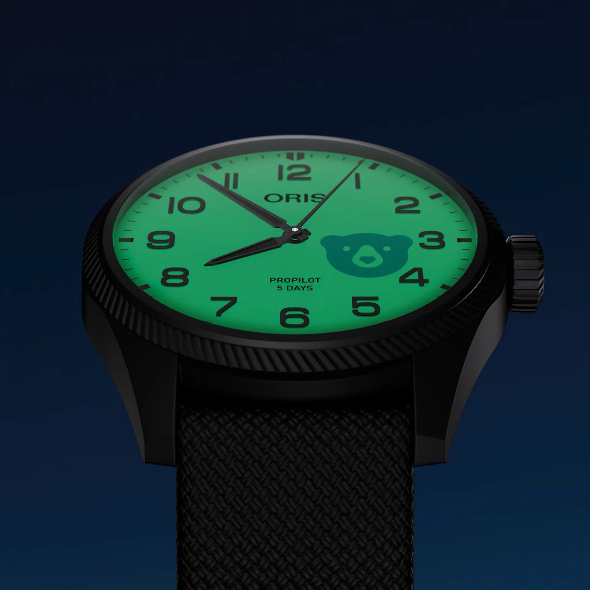 a black Oris watch with a glowing lume dial