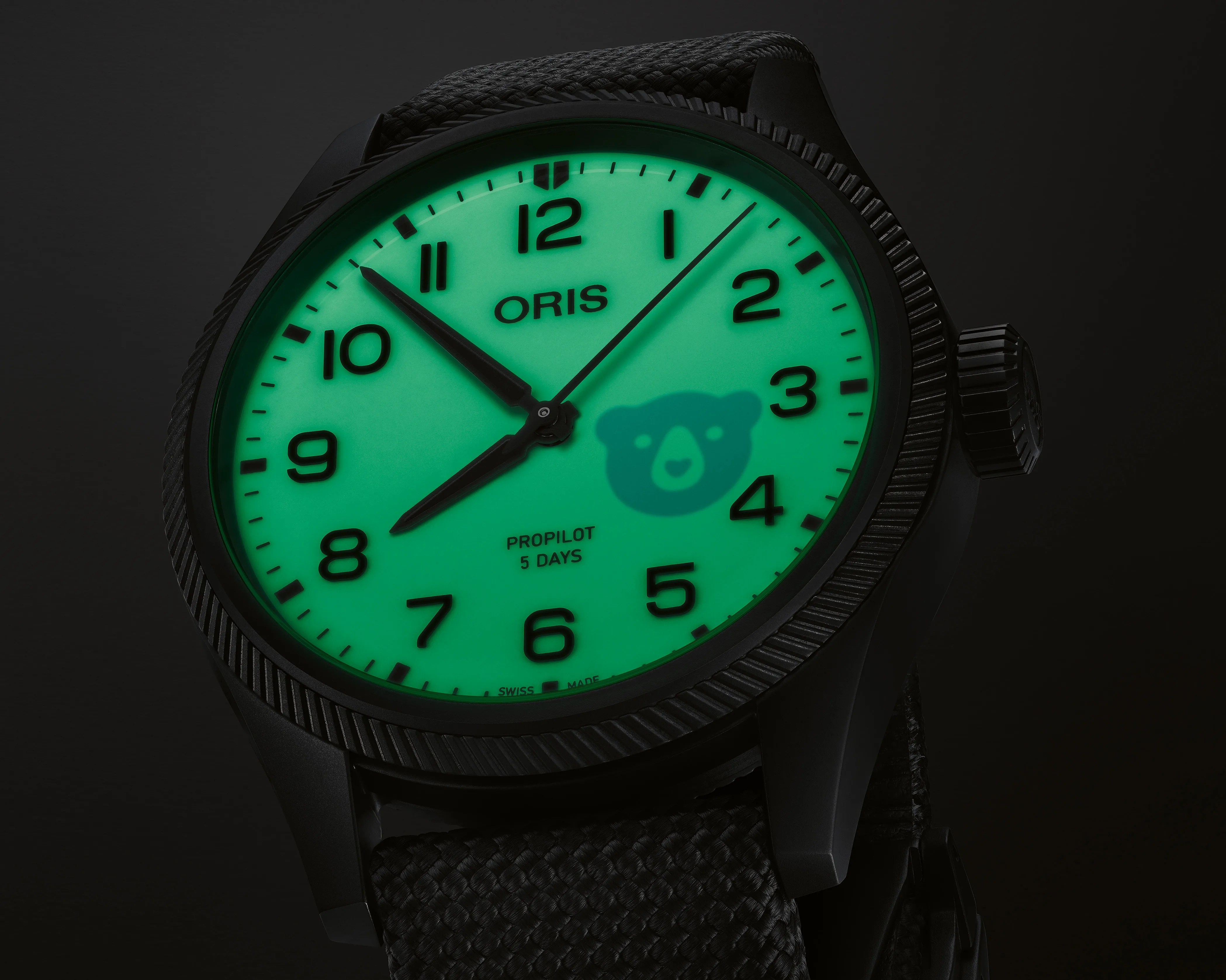 a black watch with a glowing lume dial