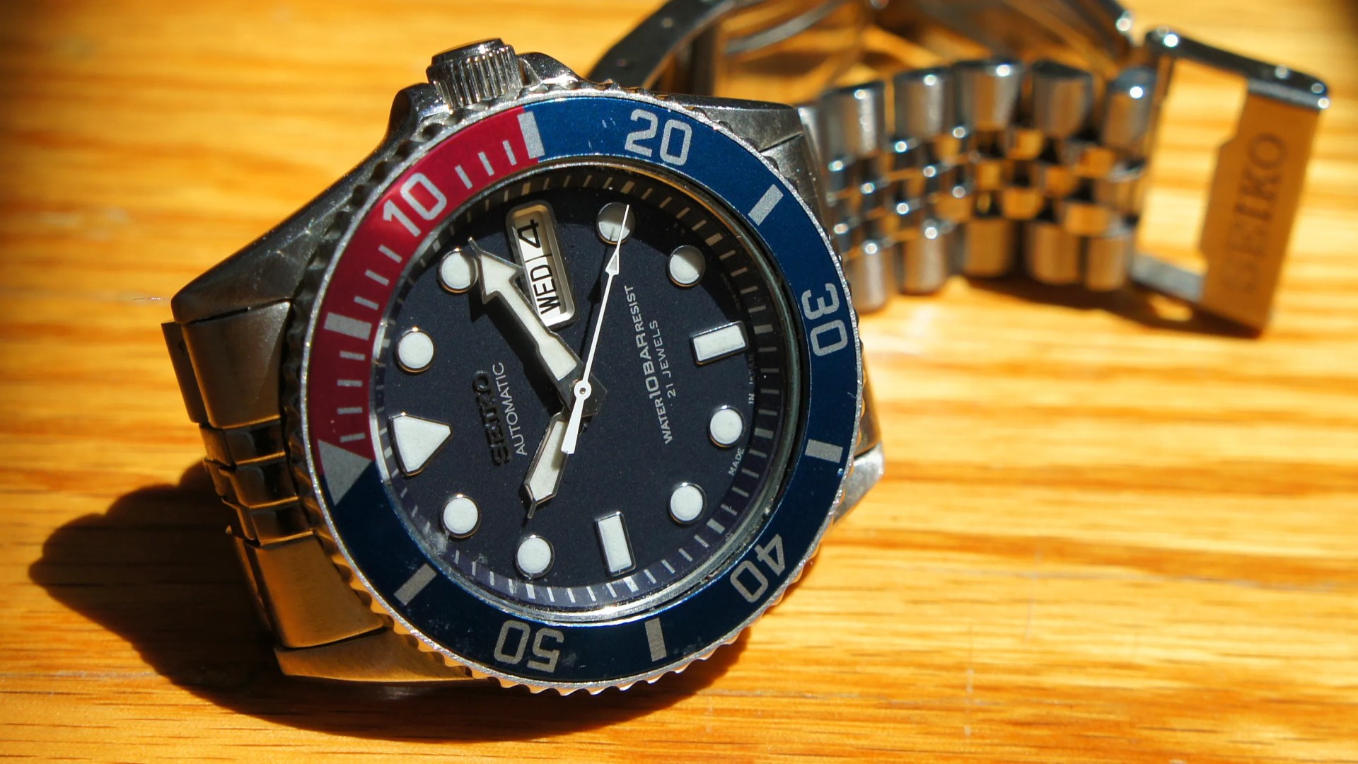 a seiko dive watch with a blue dial