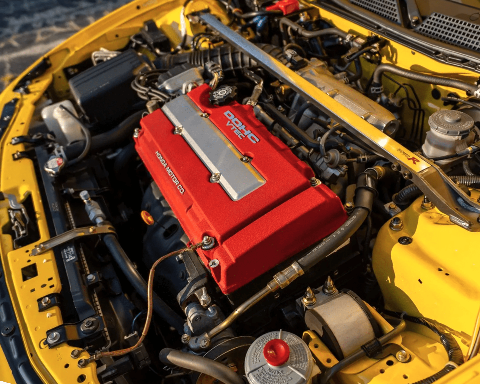 a photo of the engine bay for a yellow integra type r
