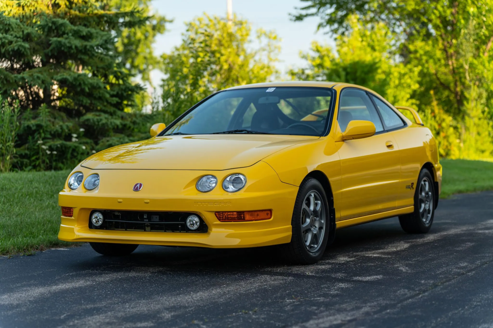 front left 3/4 photo of a yellow acura integra type r
