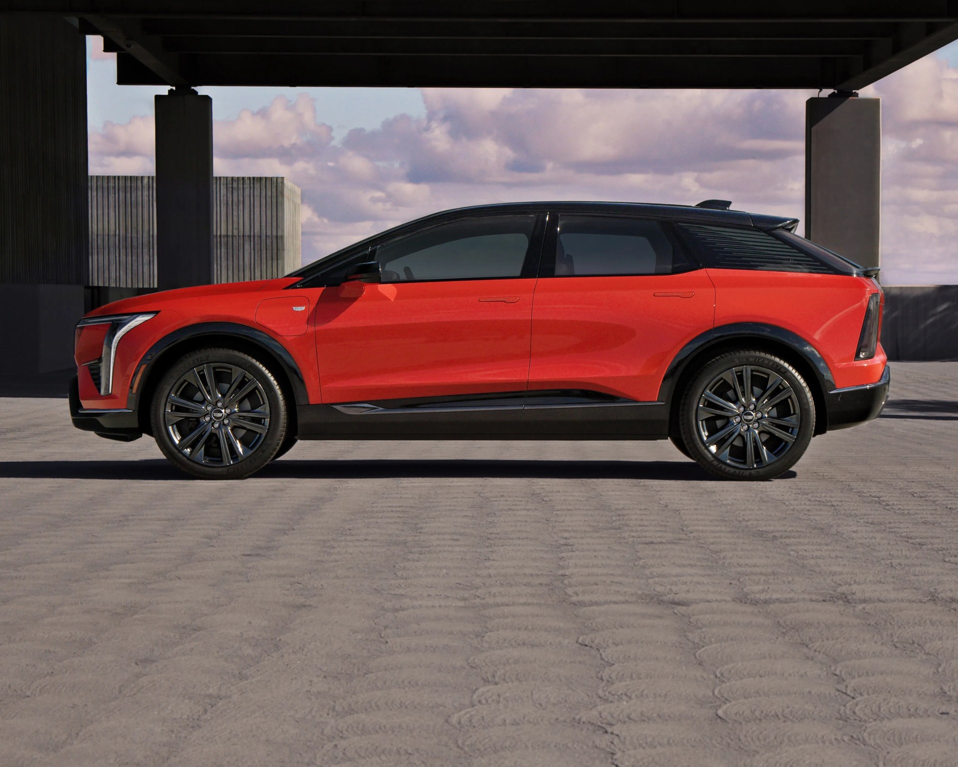 orange cadillac electric car side profile shot from low