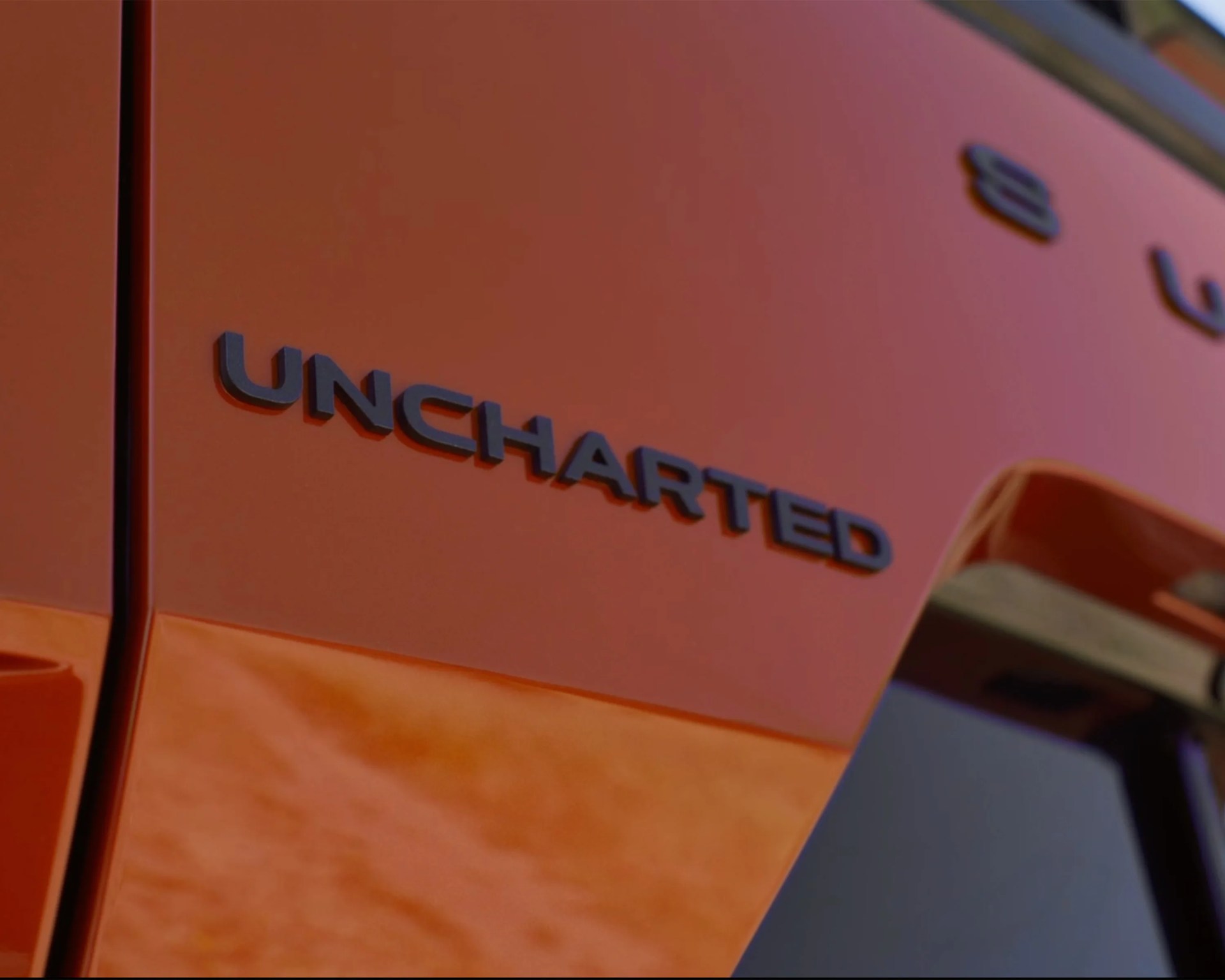close-up short of orange subaru crossover badge