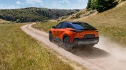 orange subaru electric crossover driving