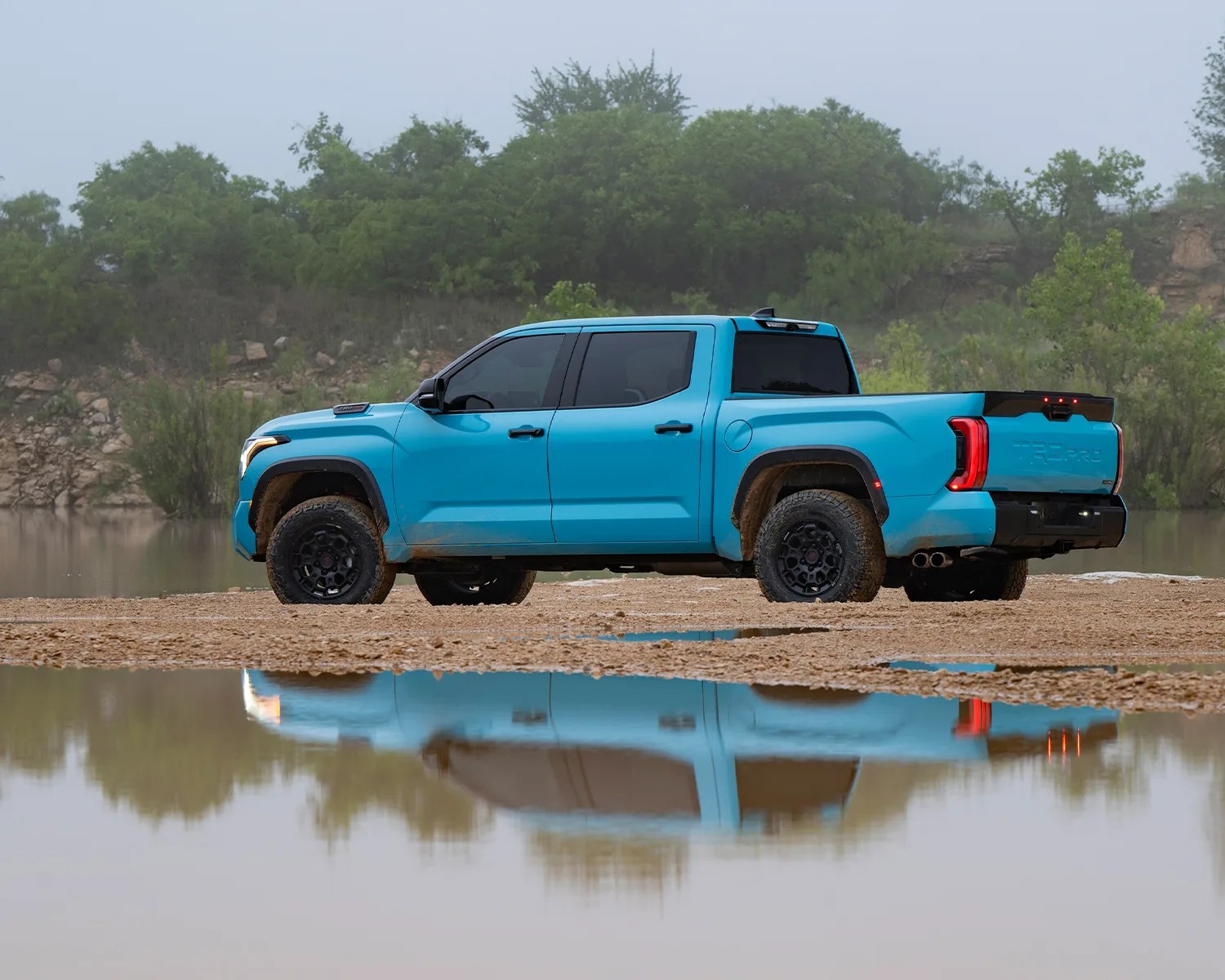toyota tundra pickup parked near puddle reflection