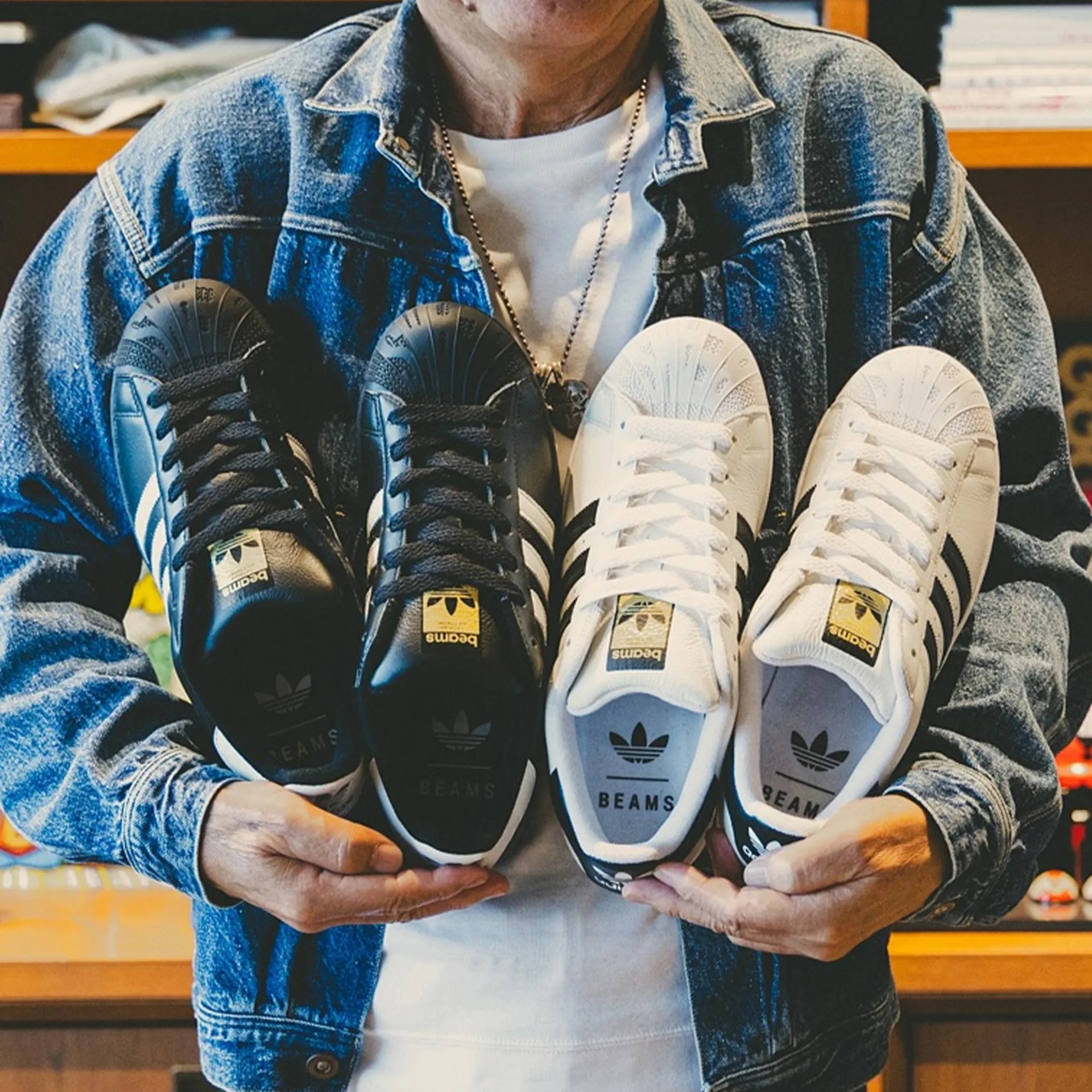 Adidas Originals × Beams Superstar II sneakers held by person in store