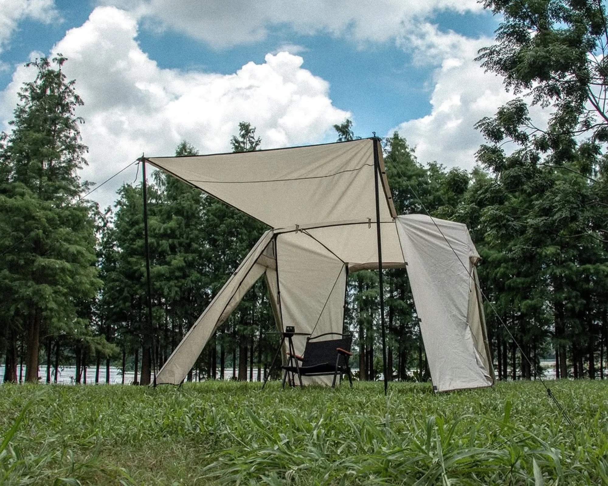 Altara Dual Awning Modular Camping Tent in pop-up tent mode with camp chair in woods