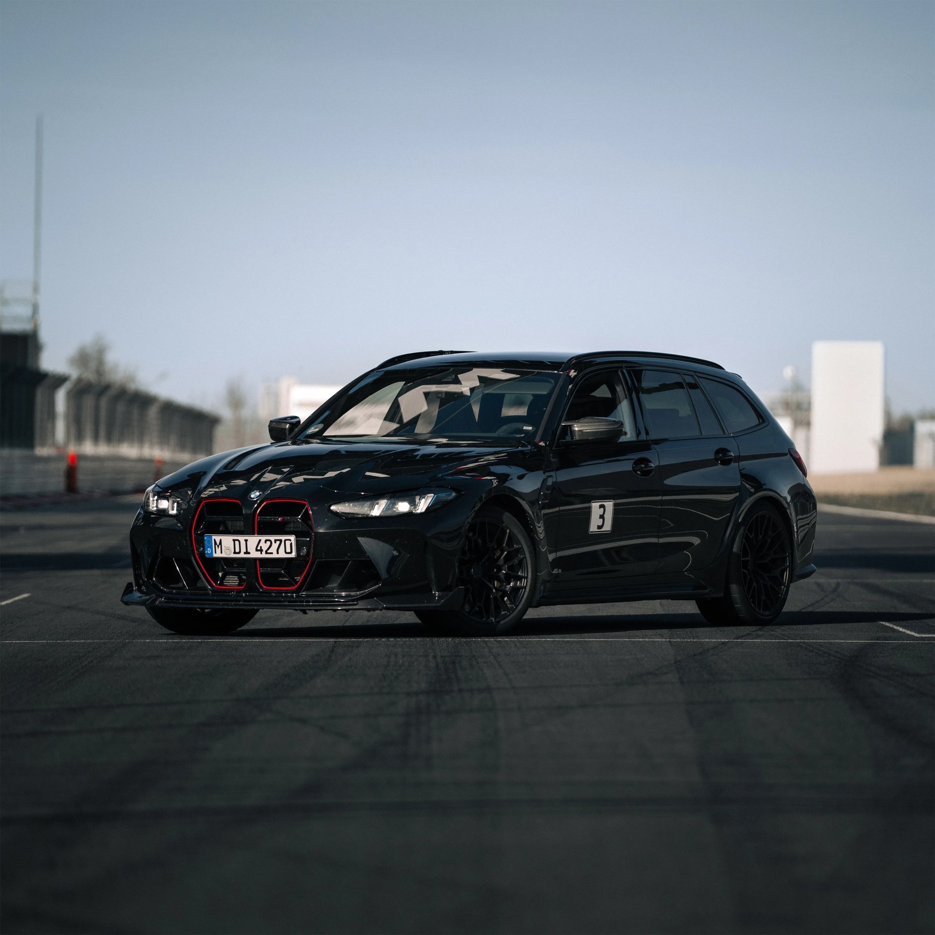 a photo of a BMW M3 station wagon on a track