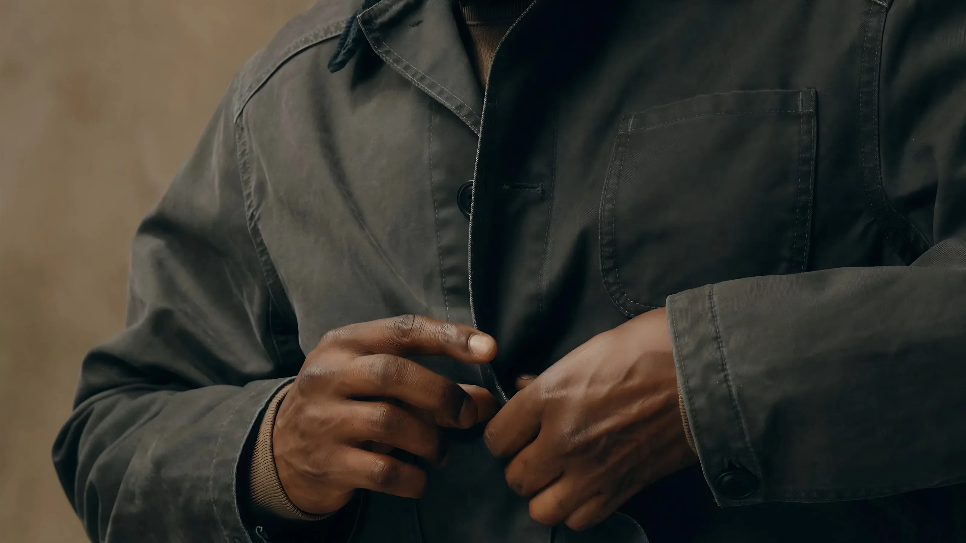 A close-up of the top button and chest area of the Filson Canvas Outfitter Jacket