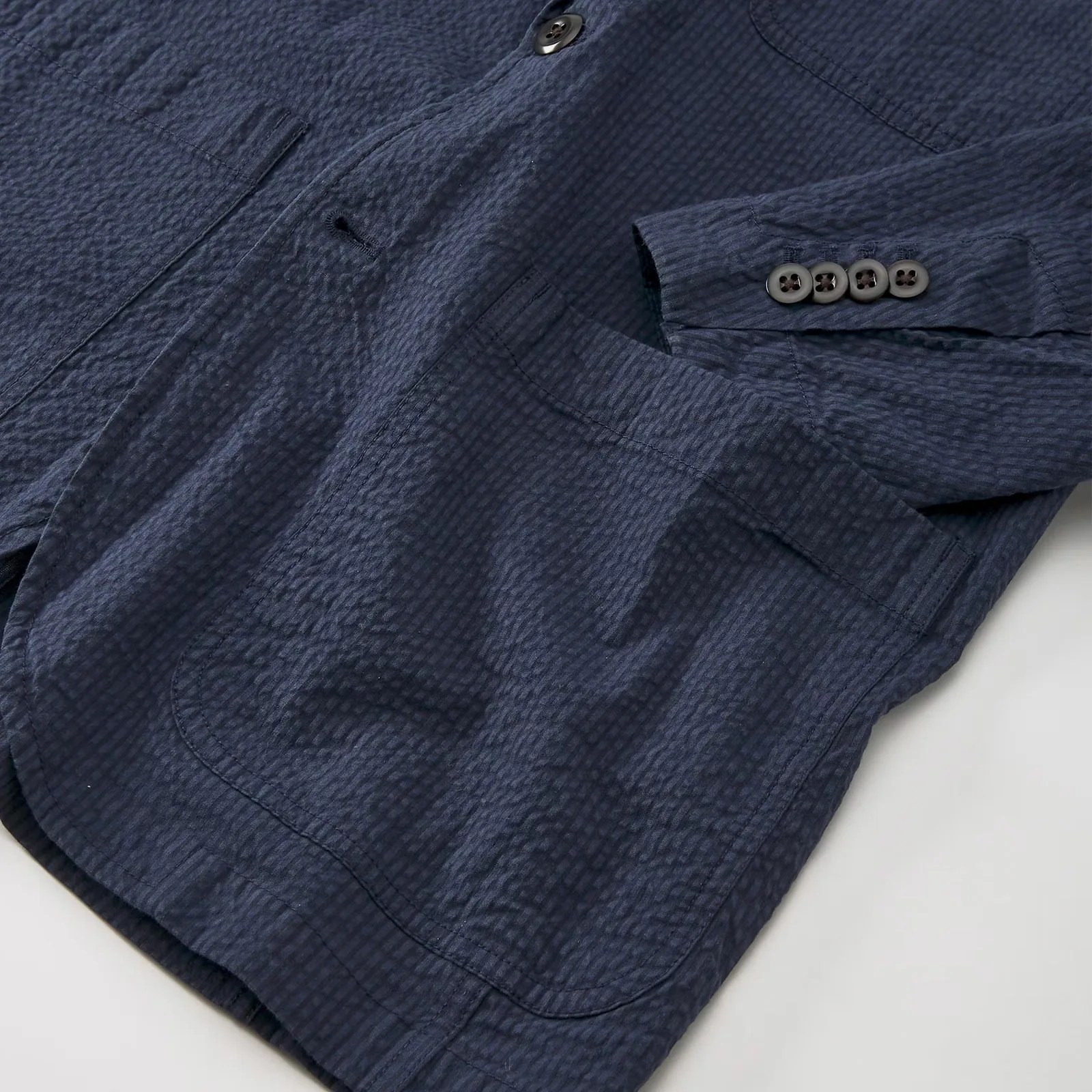 The lower right hem and pocket of the Flint and Tinder Seersucker Blazer in Navy