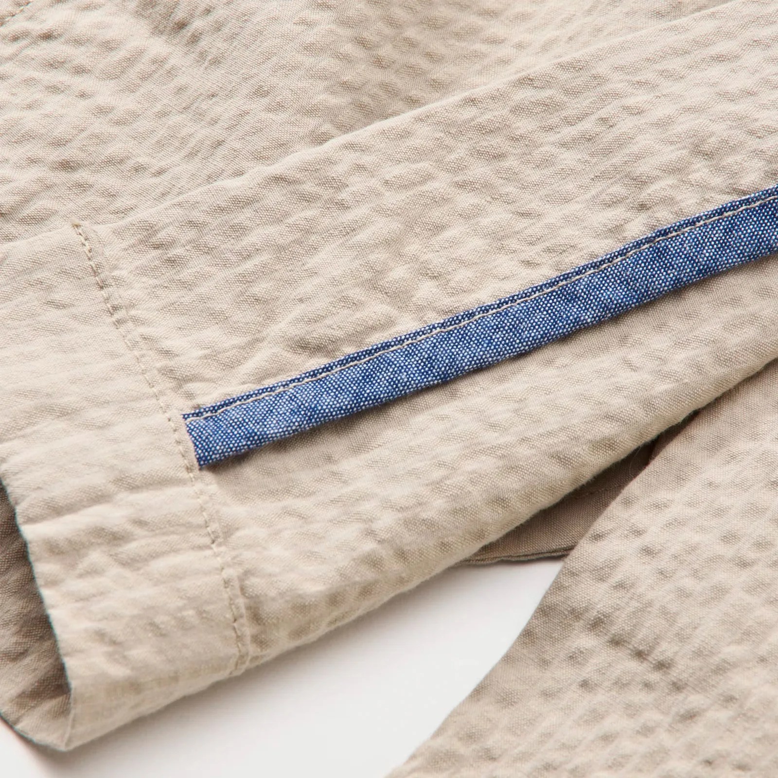 A view of the chambray lined stitching on the Flint and Tinder Seersucker Trousers in Khaki