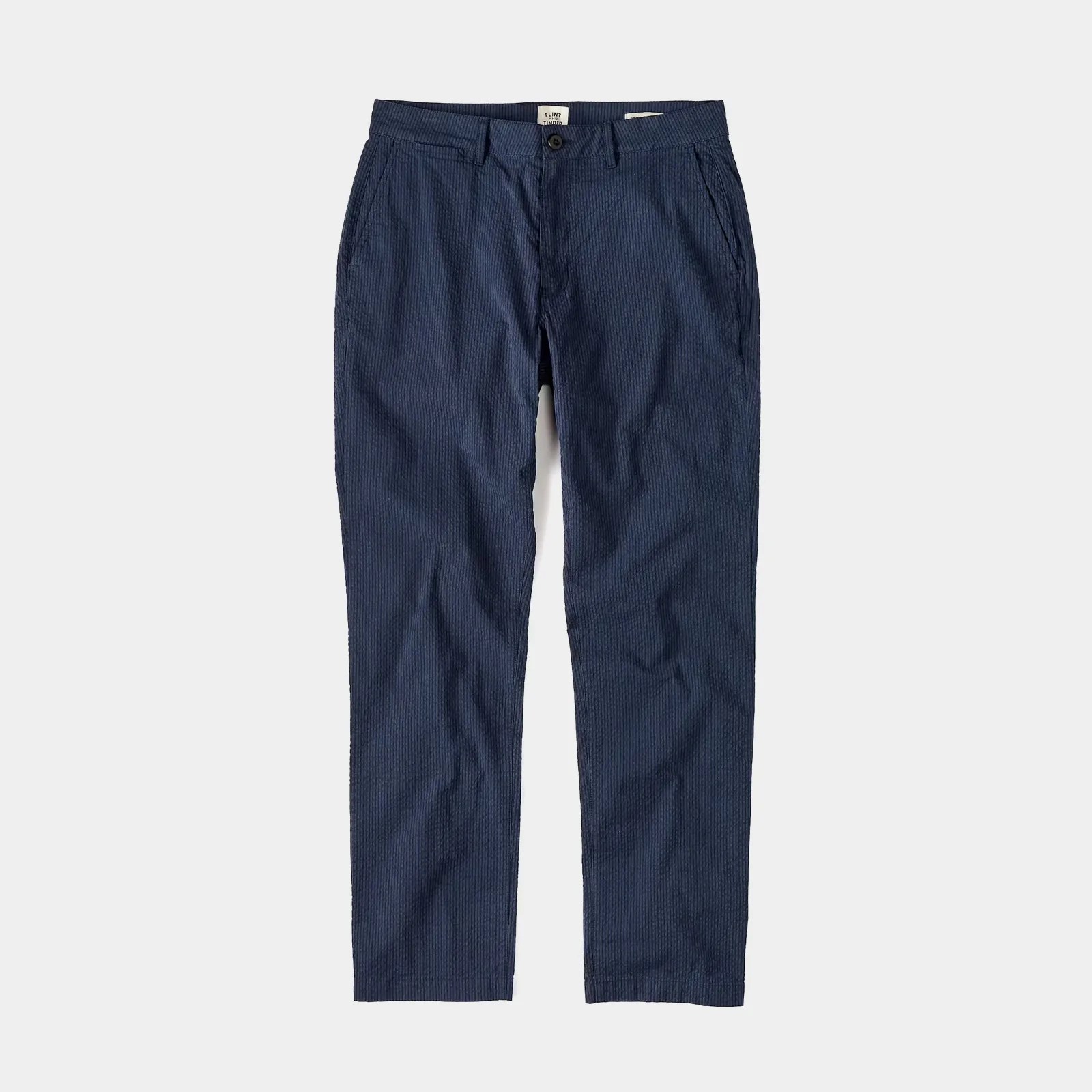 The Flint and Tinder Seersucker Trousers in Navy are shown lying flat against a light grey background