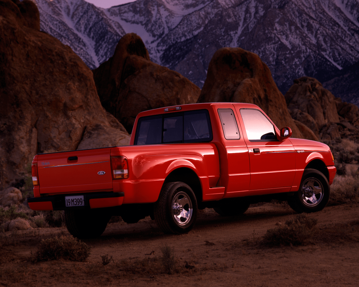 a shot of a red ford ranger with a mountainous backdrop