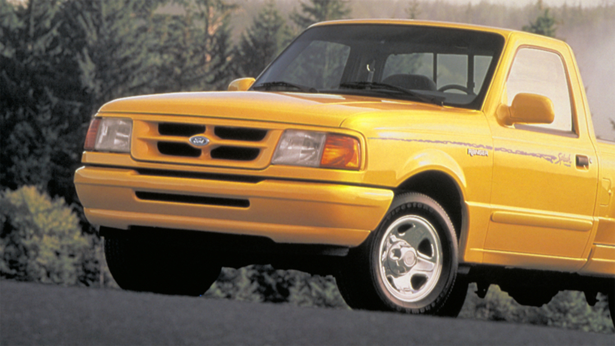 a close-up shot of a yellow ford ranger pickup