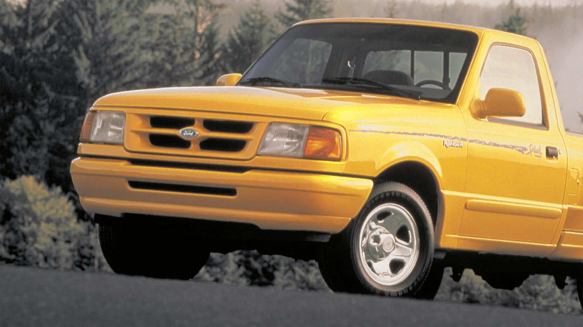 a close-up shot of a yellow ford ranger pickup