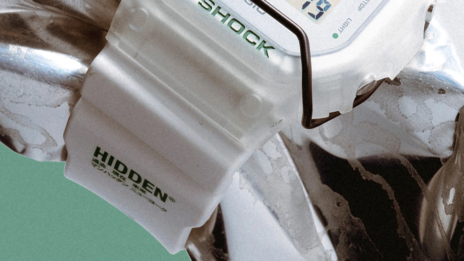 G-Shock x Hidden DW5600HDN257 Watch wrapped around aluminum can closeup