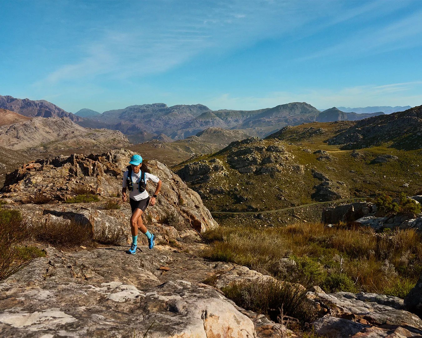 man running on dirt path wearing HOKA Mafate 5