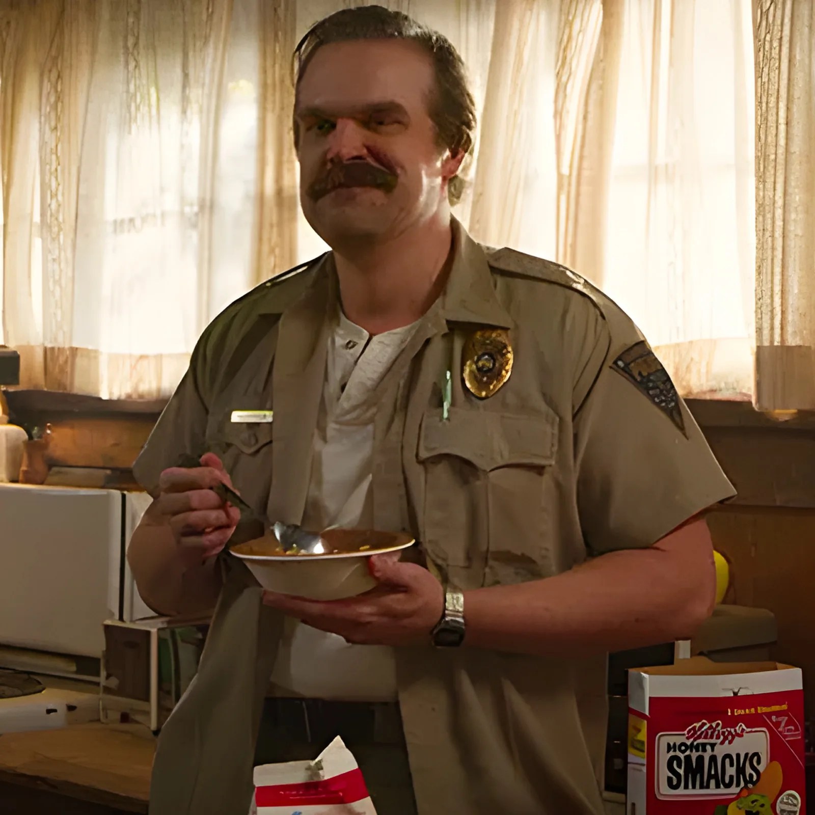 A screenshot from the Netflix TV show Stranger Things showing the character named Hopper wearing a Casio digital watch while eating cereal