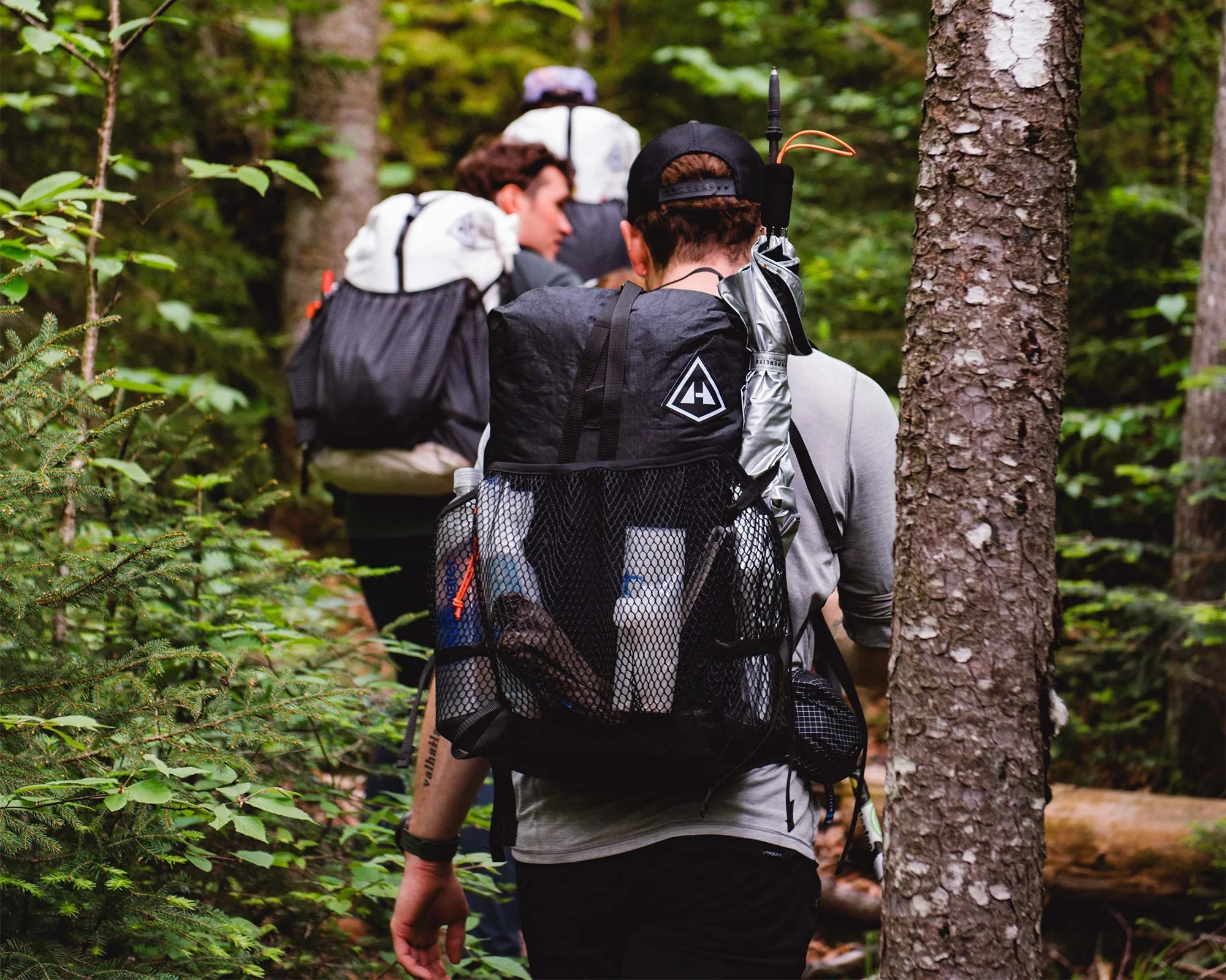 Hyperlite Mountain Gear Dyneema Packs worn by hikers in the woods