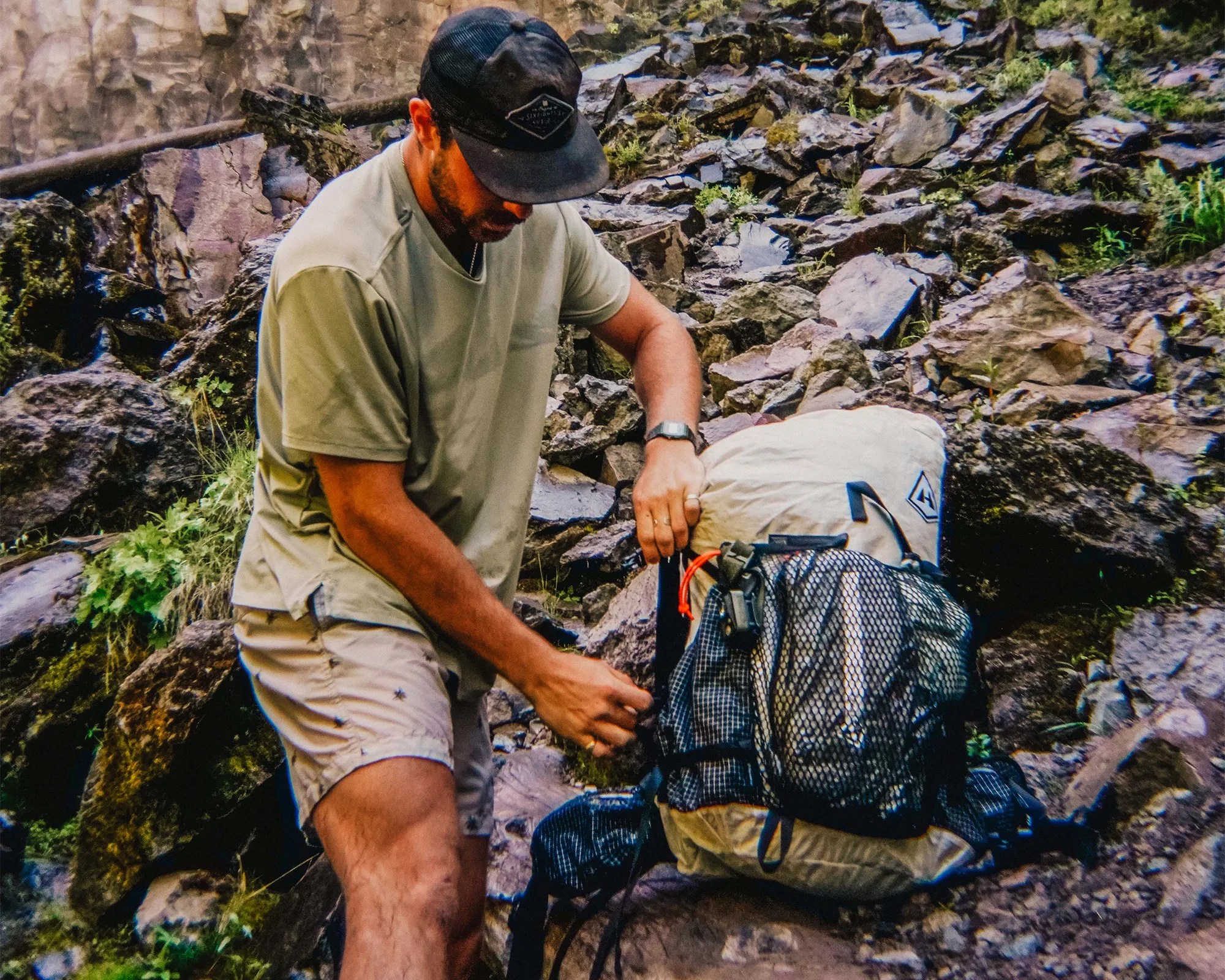 Hyperlite Mountain Gear Dyneema Pack with hiker on rocky terrain